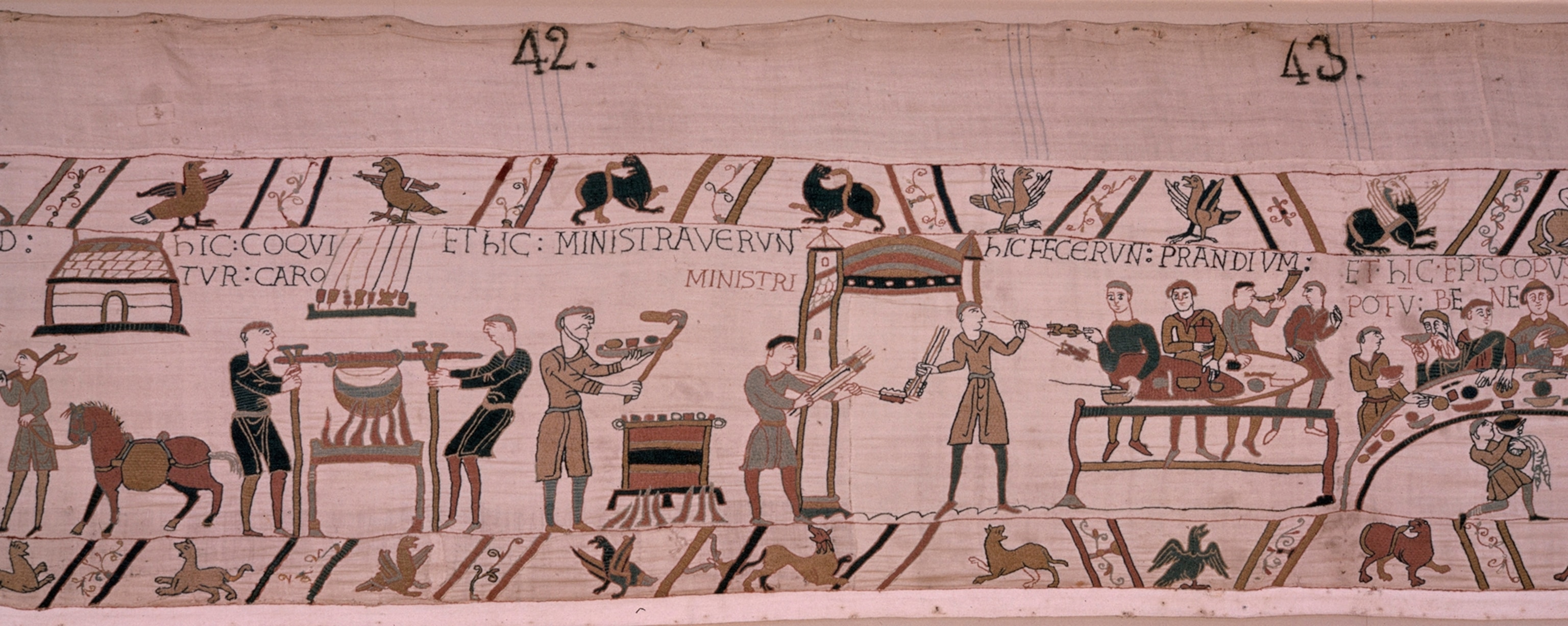 A scene from the tapestry in which the invaders eat commandeered food.