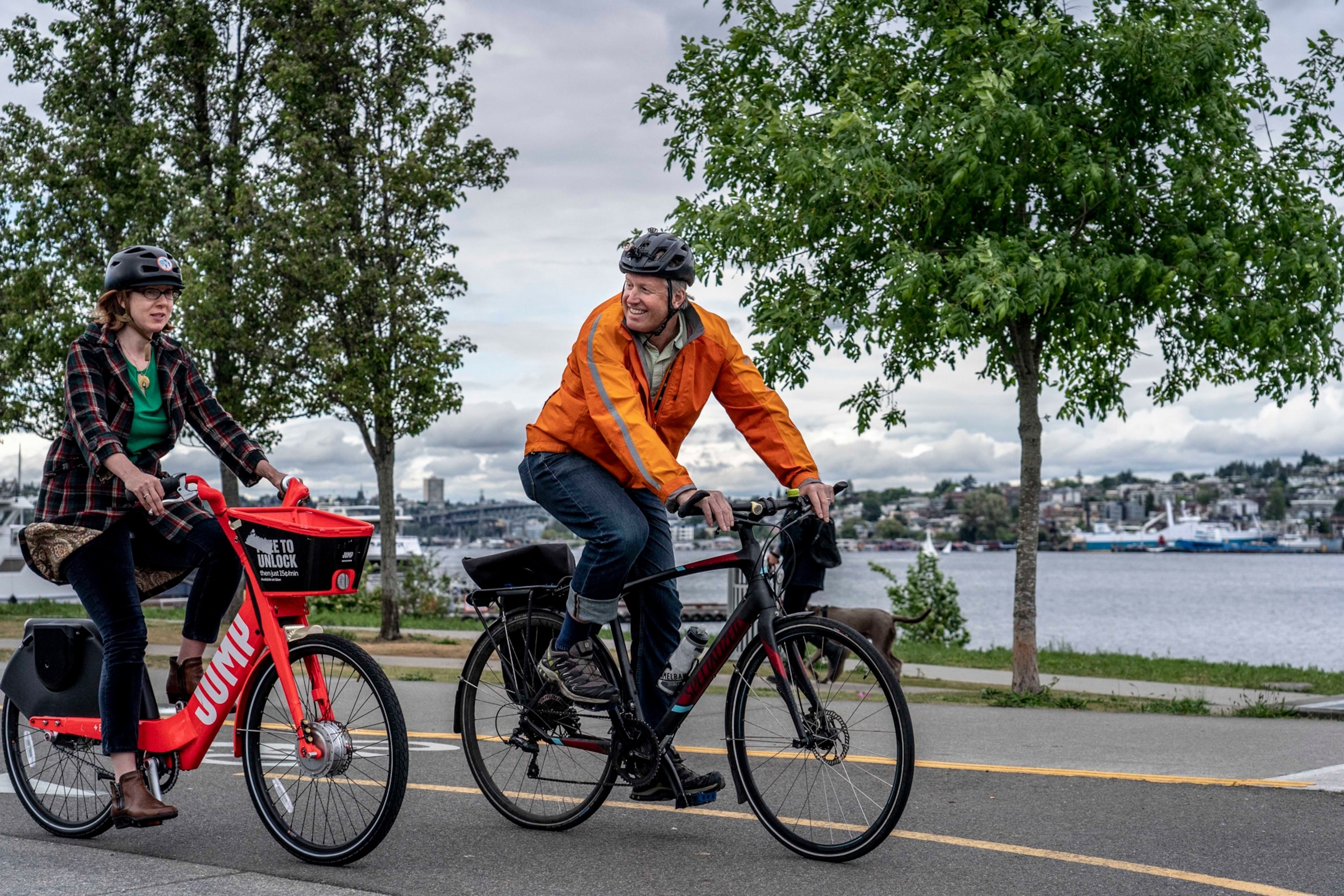 Vicky Clarke, policy director for the Cascade Bicycle Club and Mike O’Brien, Seattle city councilman, at the Westlake bike track. Seattle invested heavily in mass transit, reducing traffic at a time when its population and economy were growing.