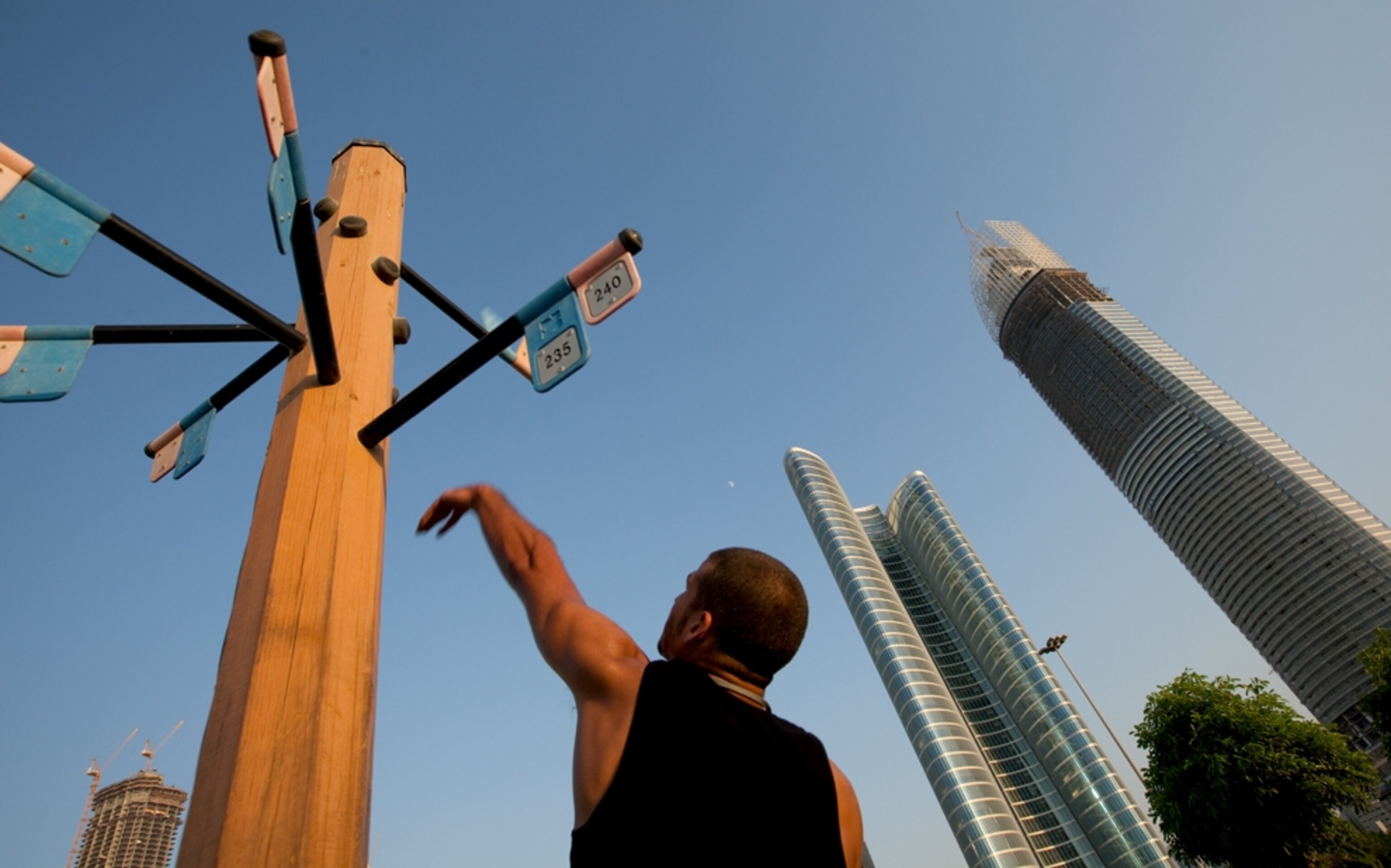 Man jumping to touch exercise flags (photo)