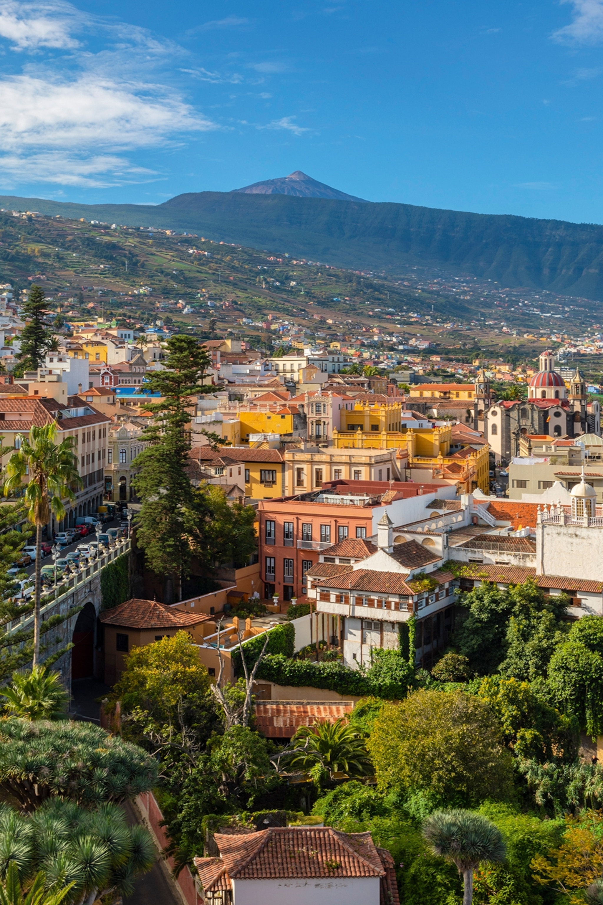 A high-altitude town with a volcano peak in the far distance.