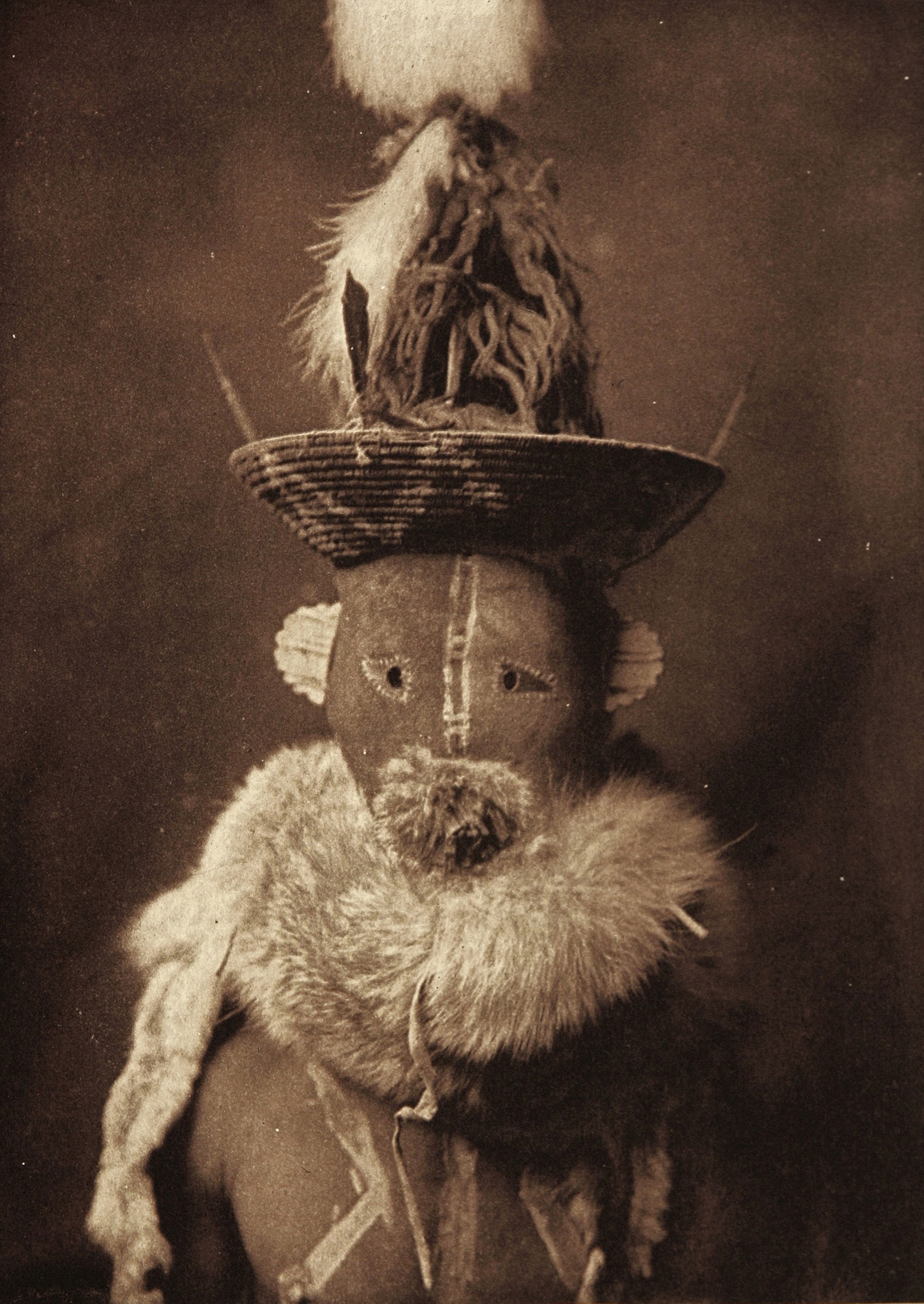 Native American man in ceremonial clothing.
