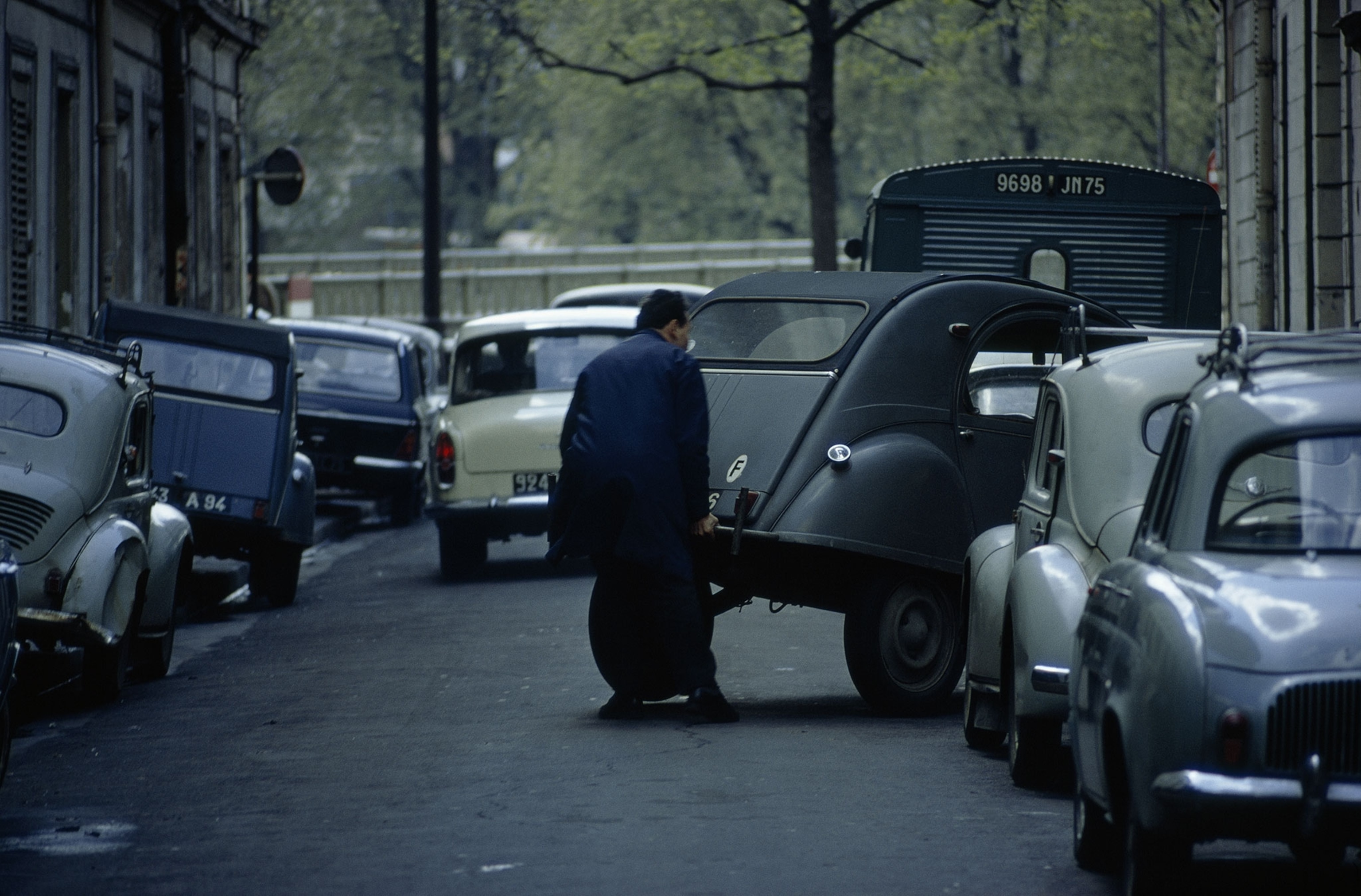 man and a street full of cars