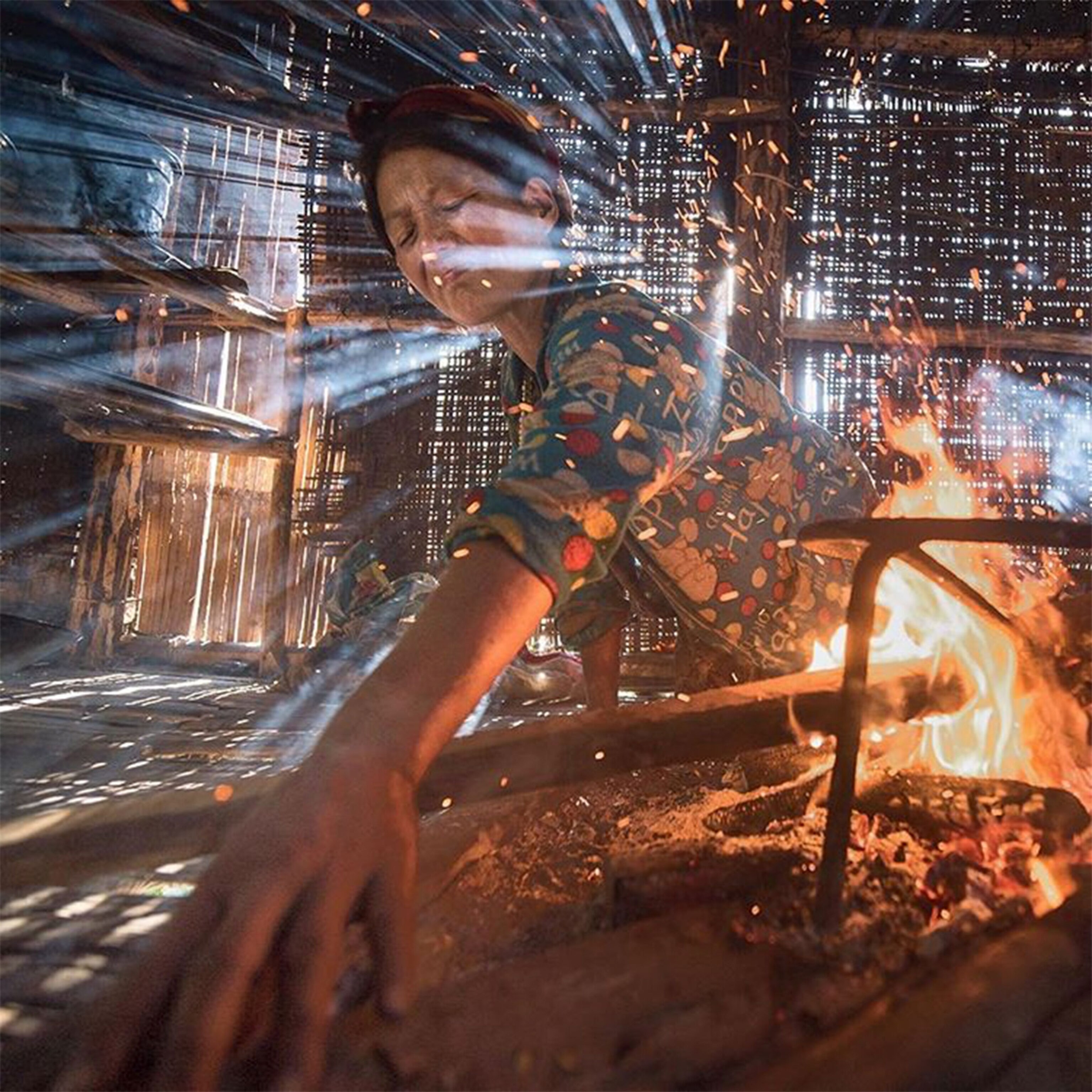 a woman cooking over a fire