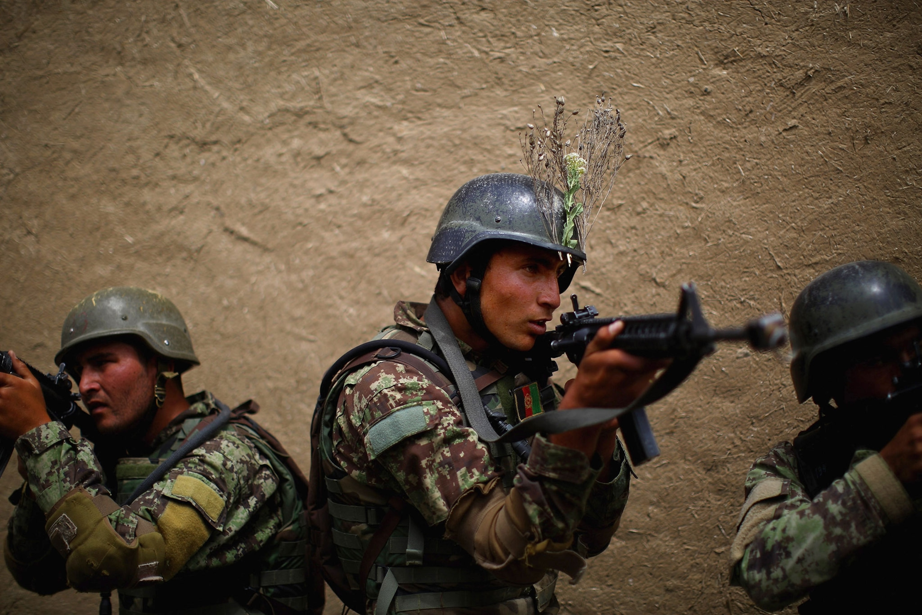 Afghan commandos line up outside the walls of a mock compound