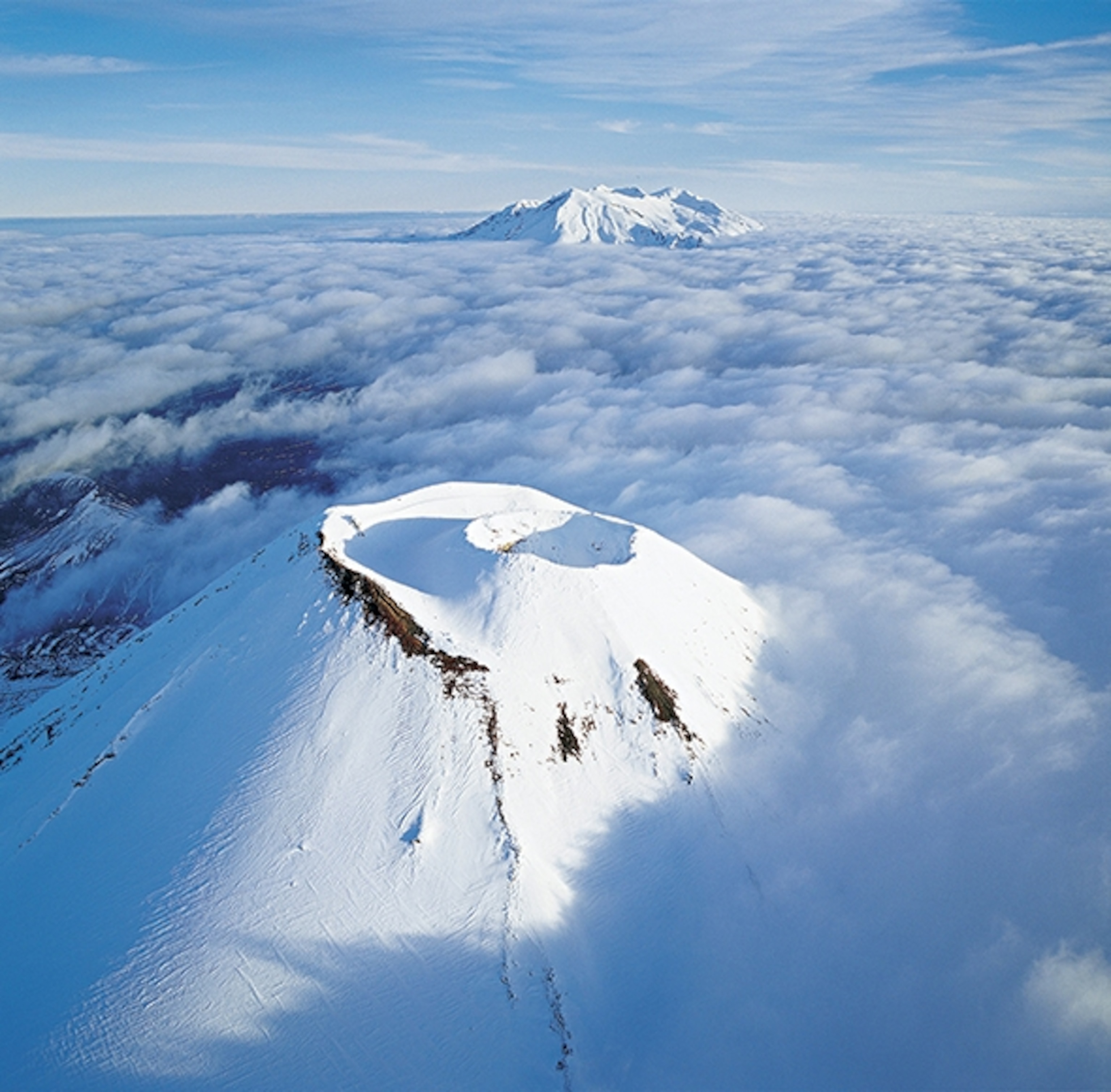 Lords of the Ring of Fire: New Zealand's Ngauruhoe and Ruapehu volcanoes rise above the clouds. (Photograph by Colin Monteath/Getty Images)