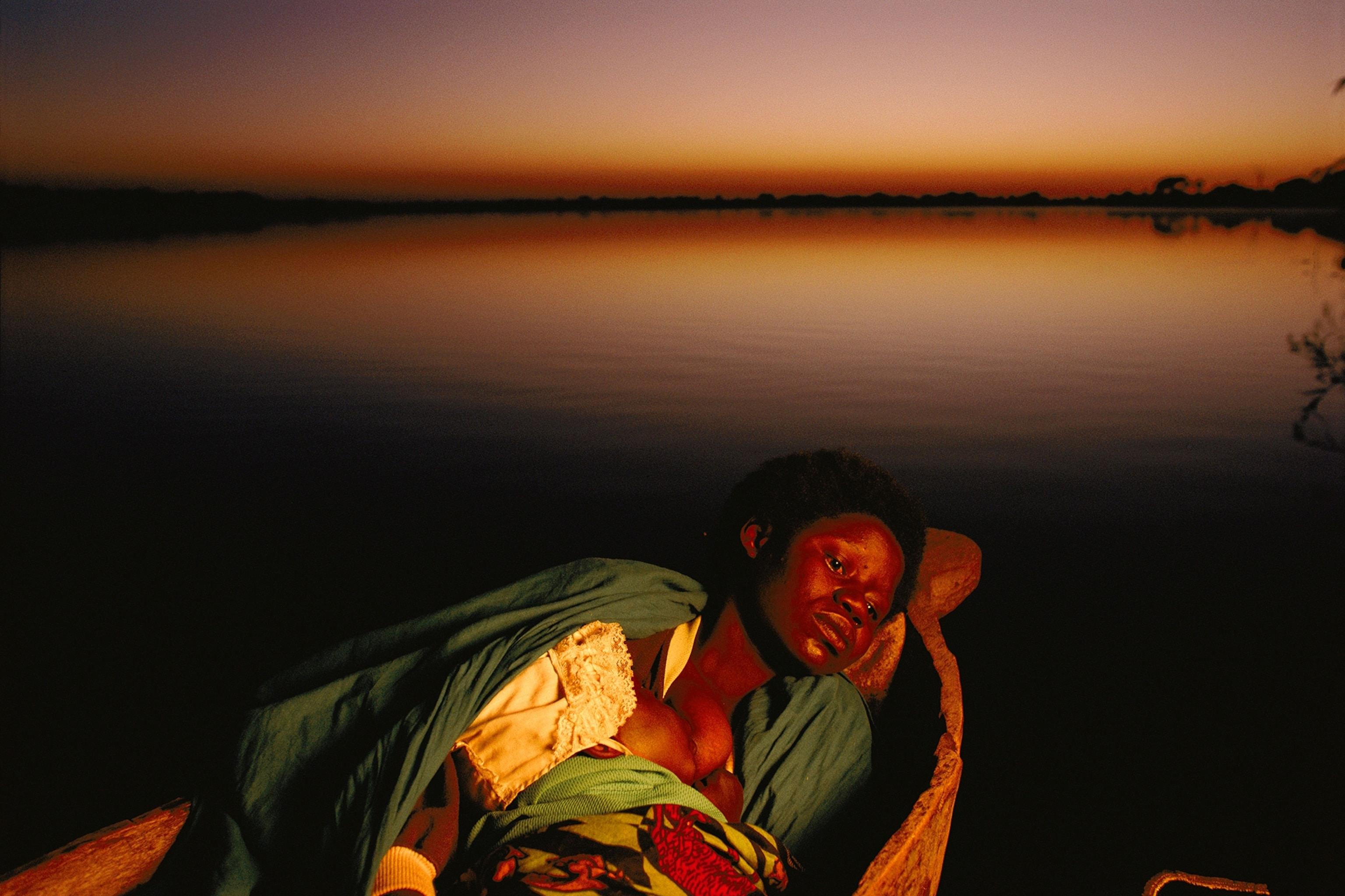 A woman nurses her baby before attending church.
