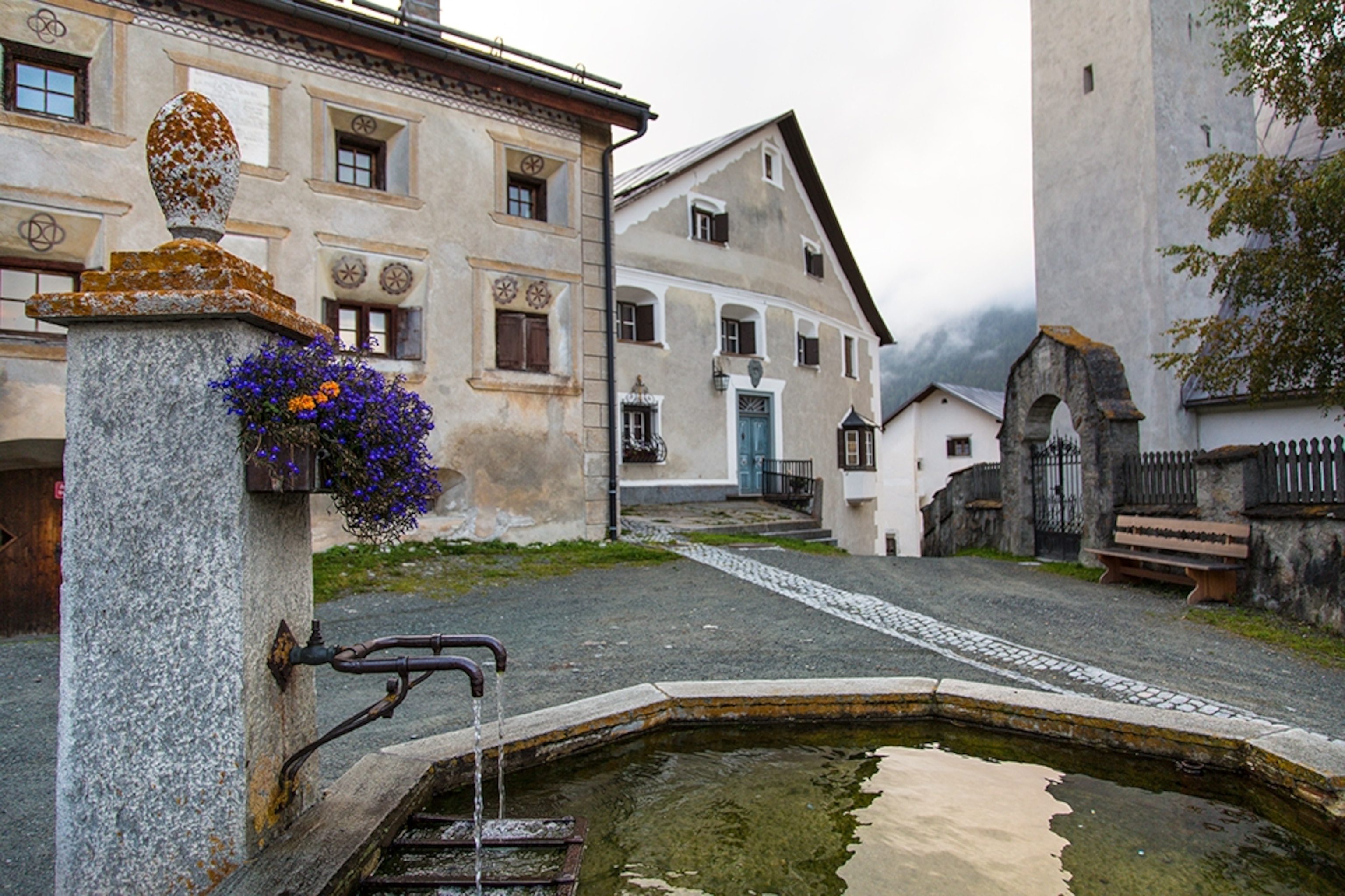 a fountain in a village square in Guarda, Lower Engadine, Switzerland