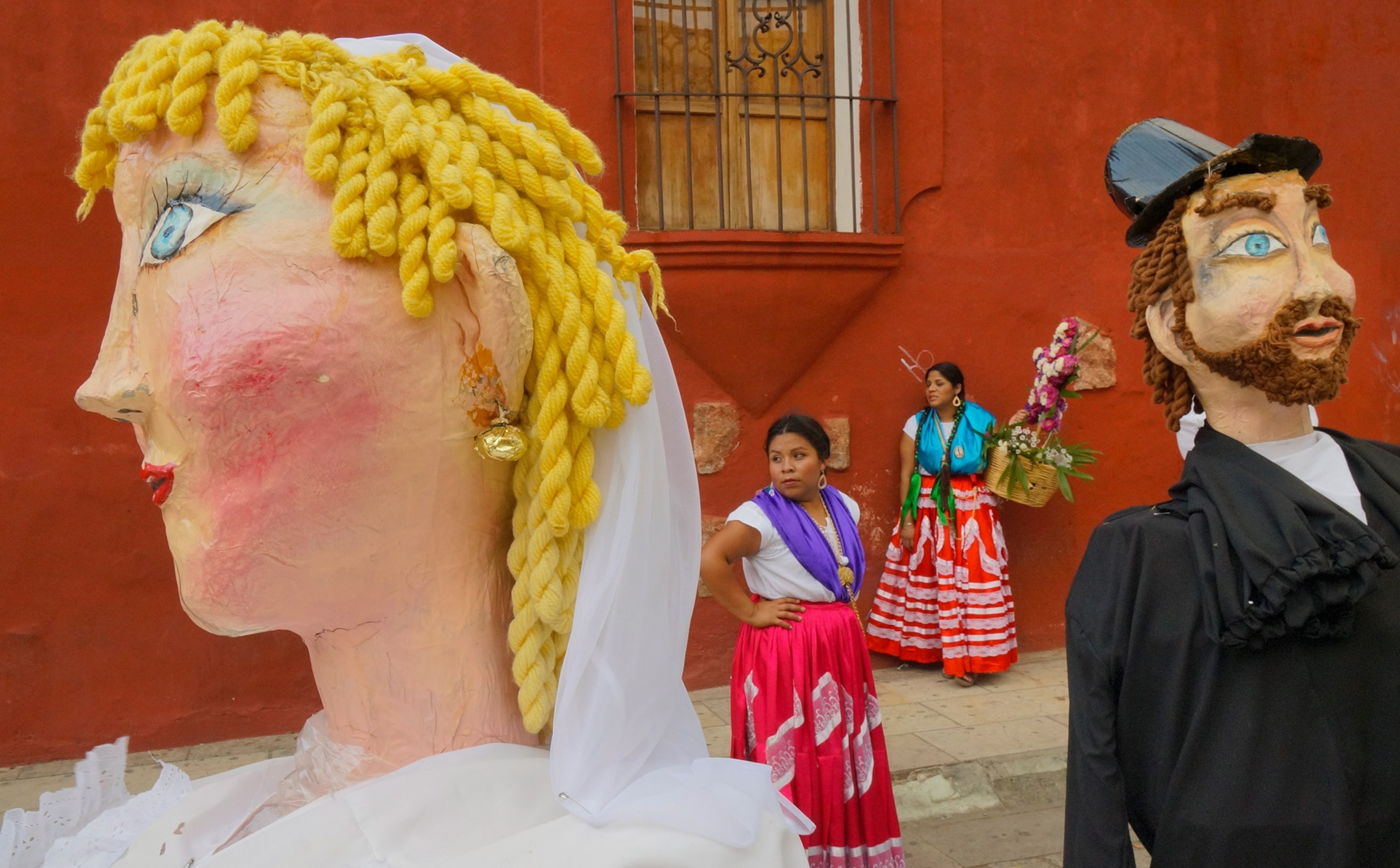dancers and large puppets after a procession through the streets