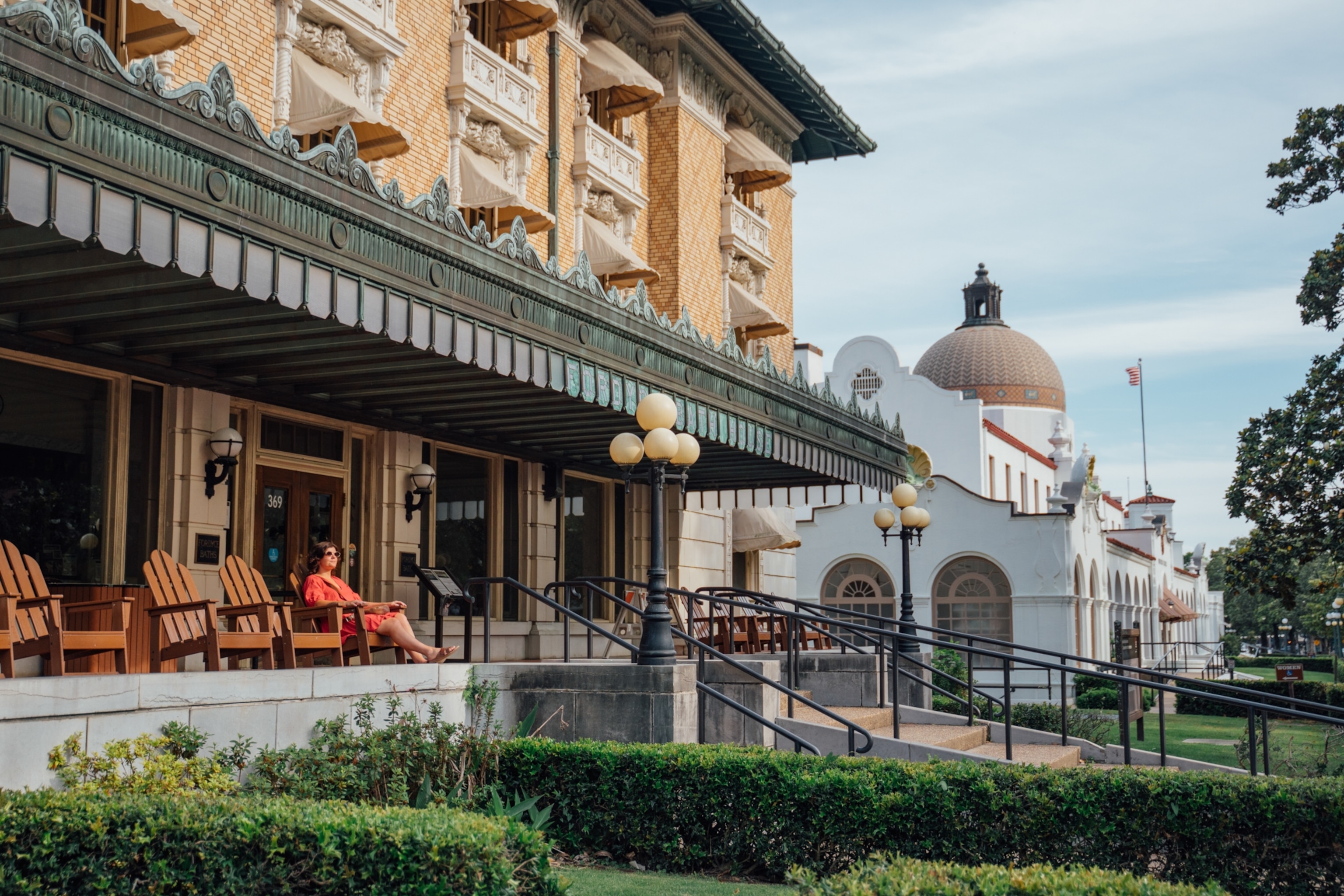 A visitor enjoys a quiet afternoon along historic Bathhouse Row in Hot Springs National Park, Arkansas