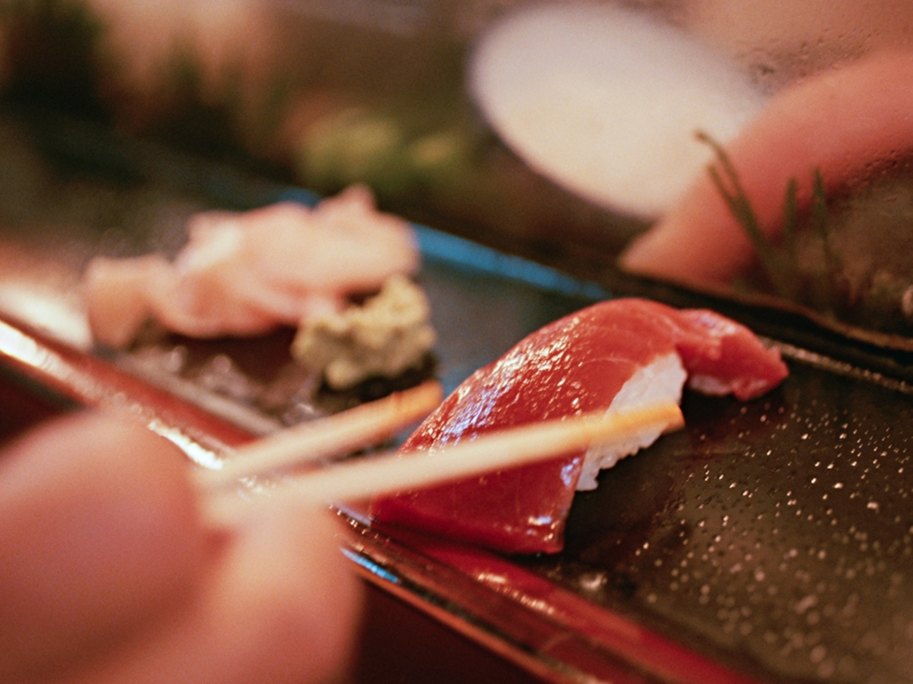chopsticks picking up sushi in Tokyo, Japan
