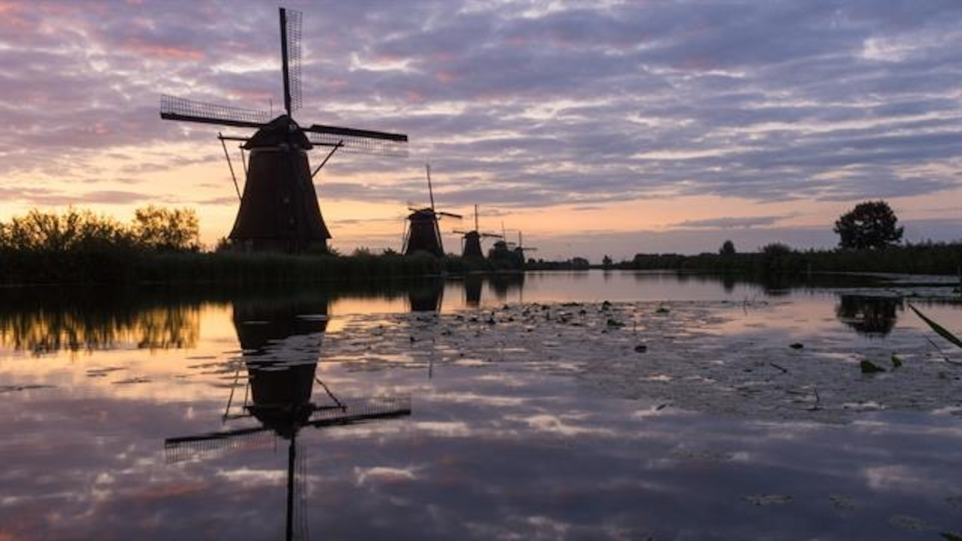 See the Windmills of Kinderdijk in the Netherlands, a UNESCO World Heritage Site