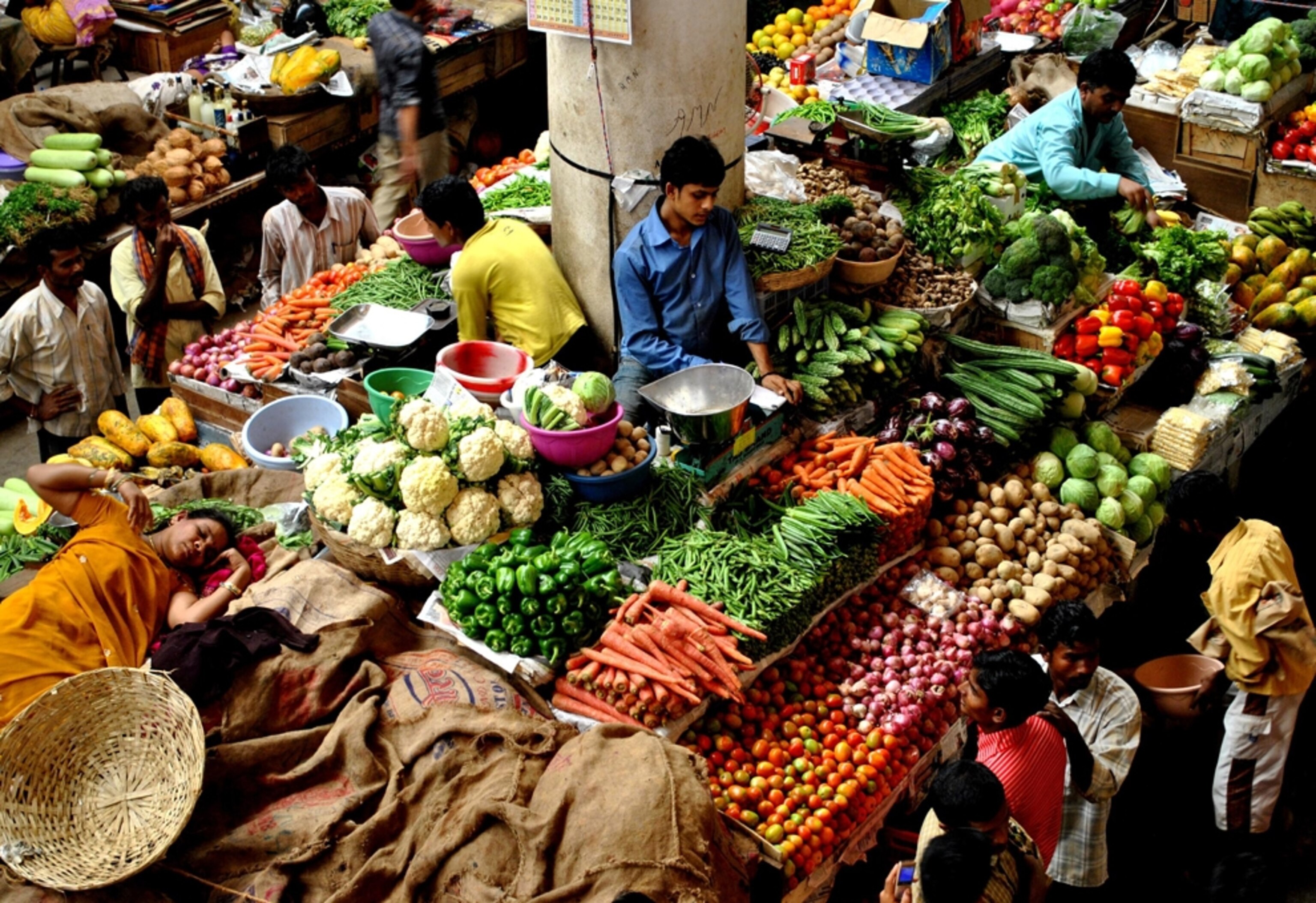 Vendors sell vegetables at a market