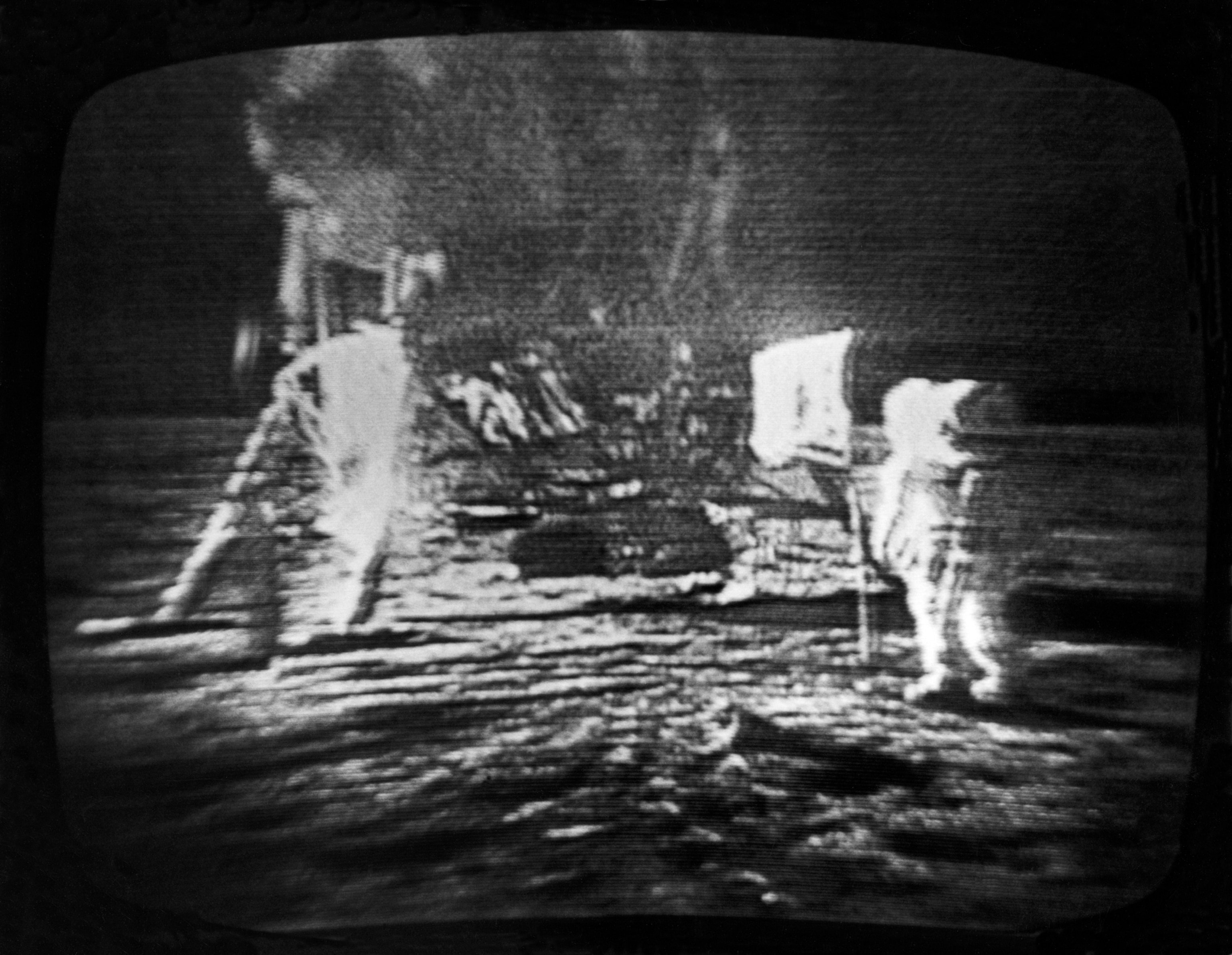 A televised view of the Apollo 11 astronauts walking on the moon.