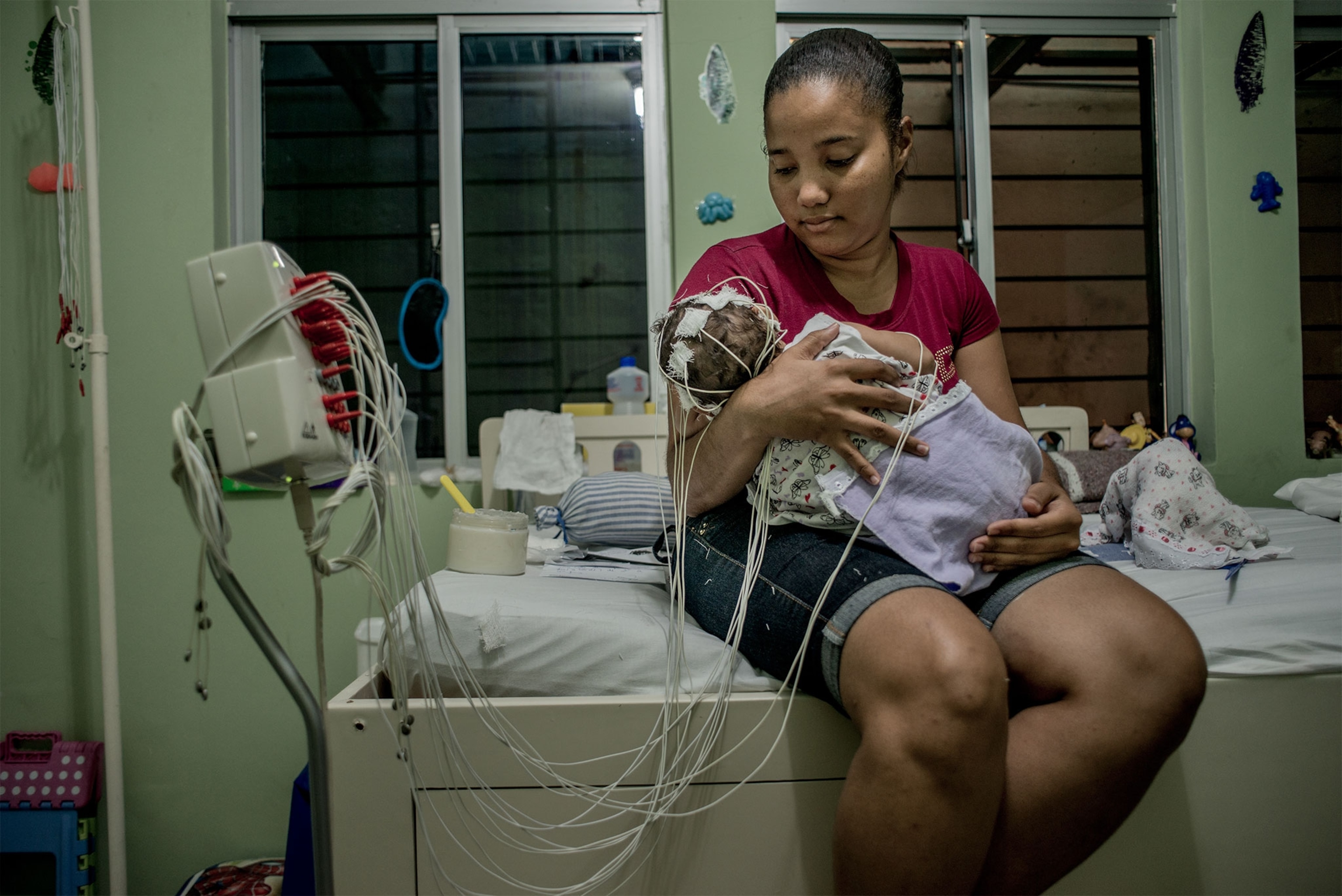 a mother holding a baby while being tested