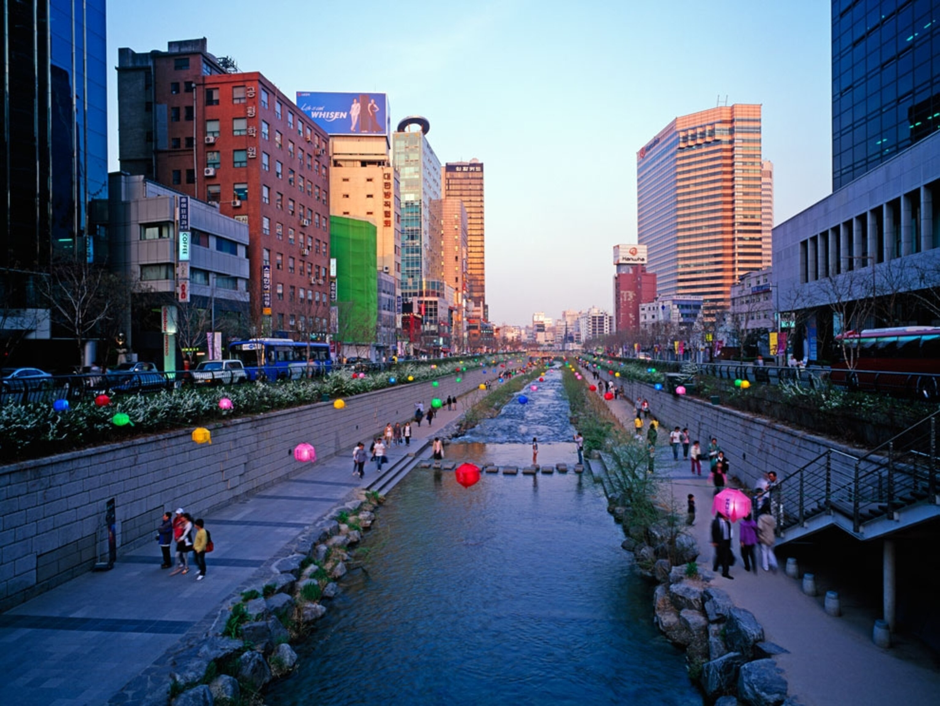 People strolling along a restored creek in Seoul
