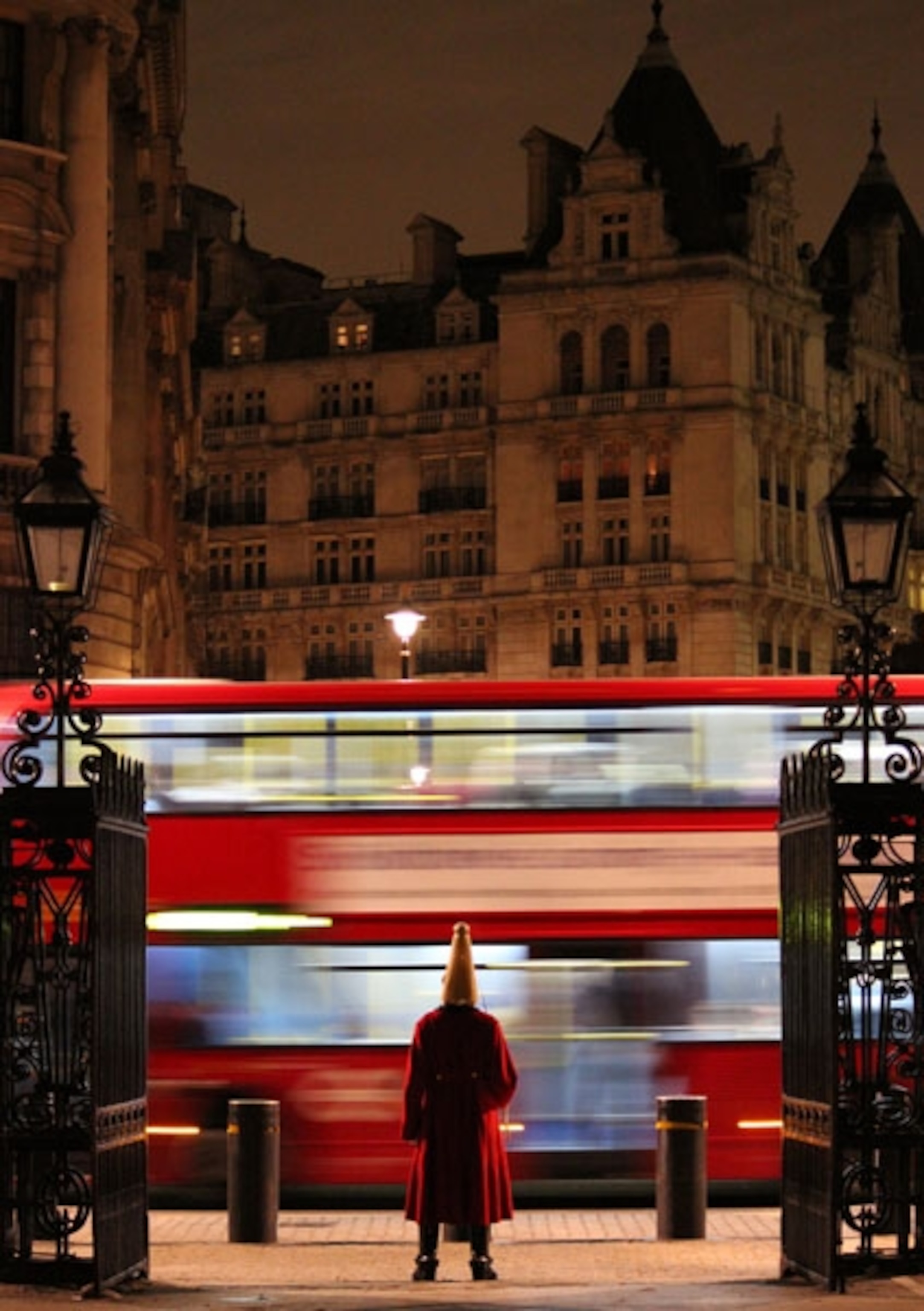 A London bus passing a horse guard in uniform