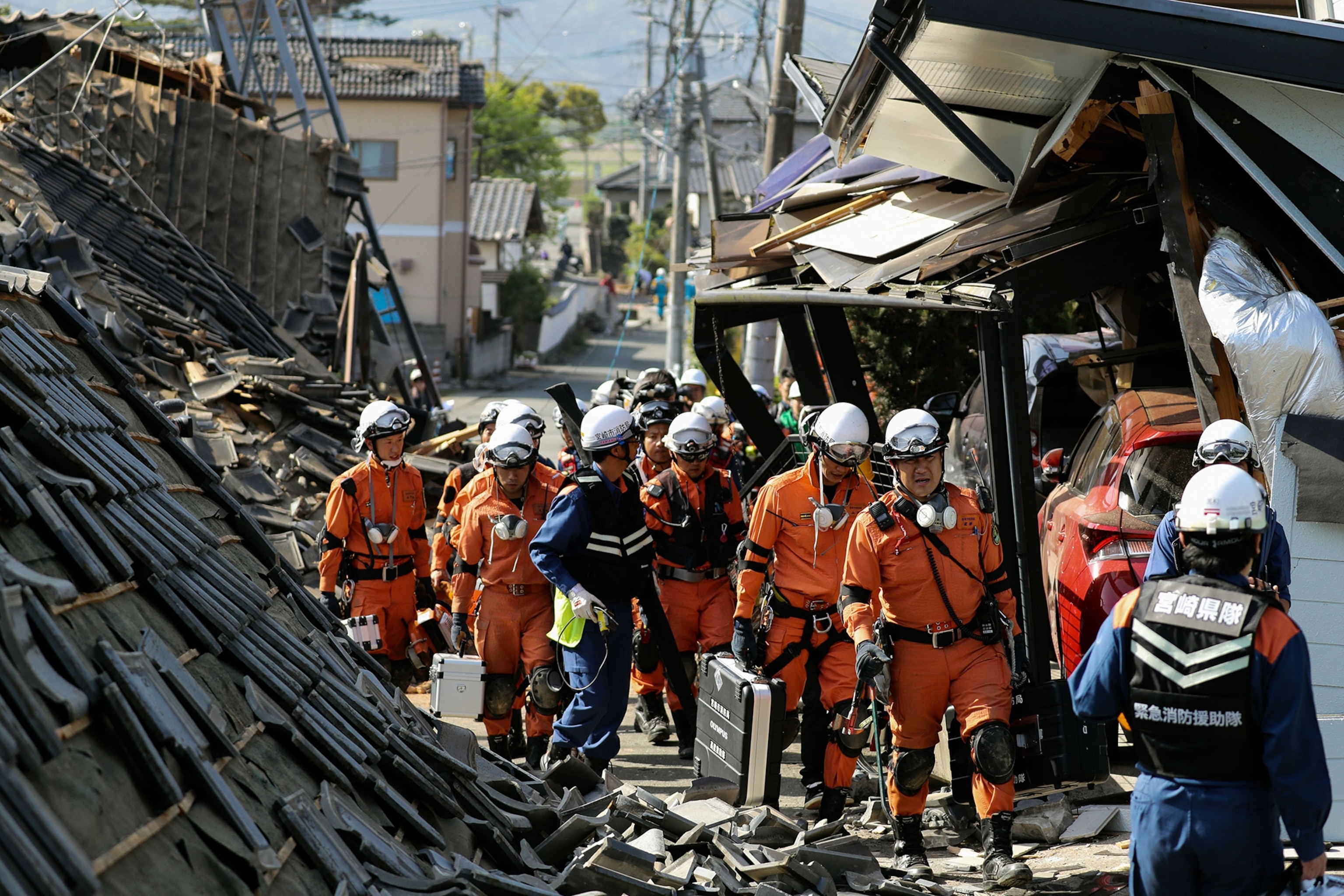 rescuers in rubble after an earthquake in Japan