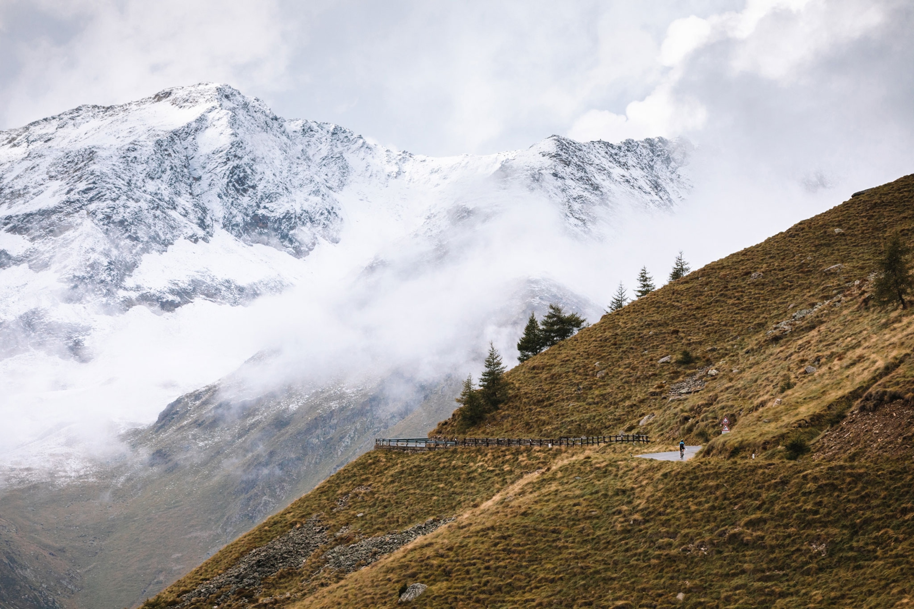 a cyclist riding up the Passo Di Gavia, Italy