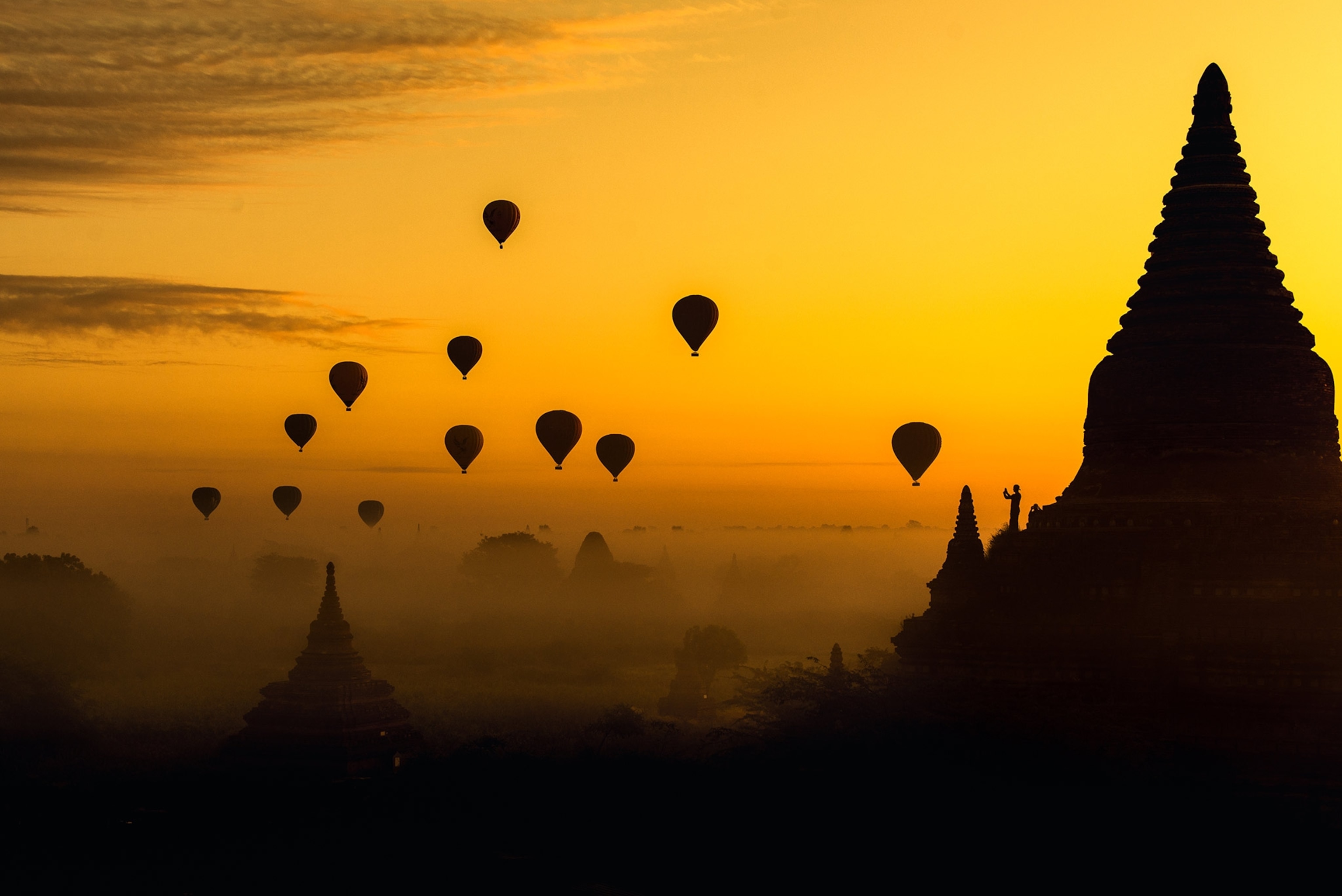 balloons floating at sunrise in Myanmar
