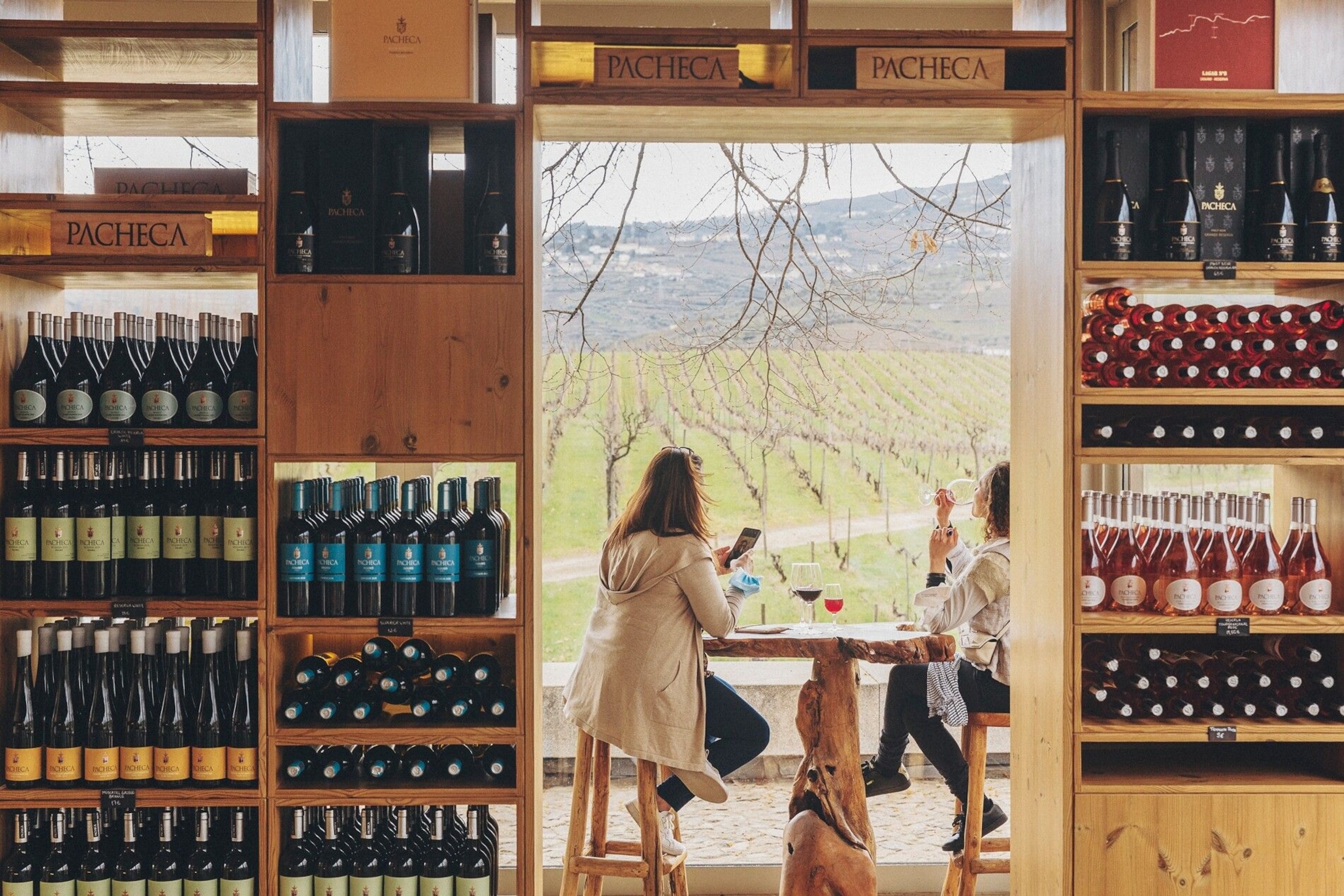 Guests enjoy a glass at Quinta da Pacheca’s modern wine shop and visitor centre.