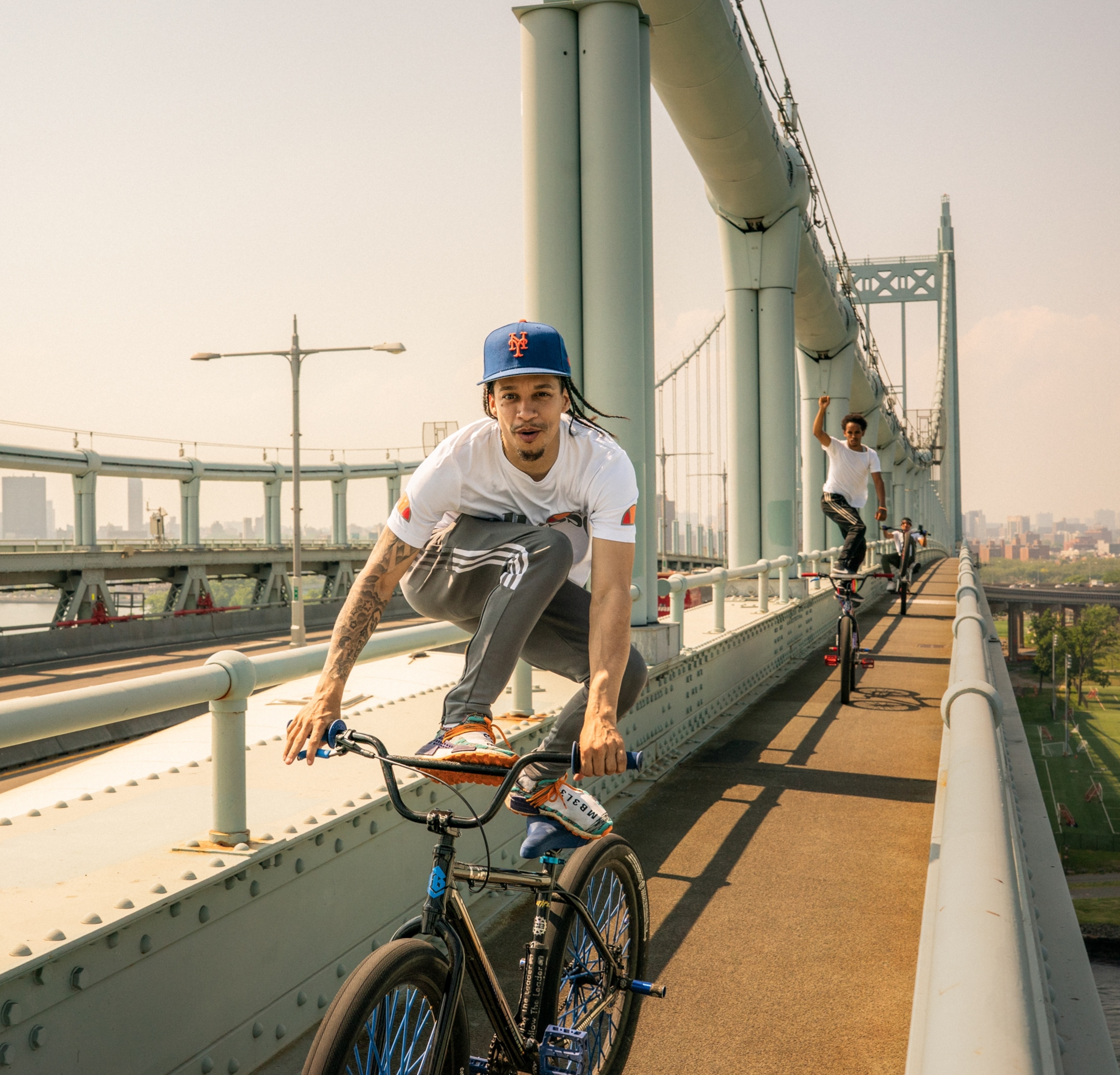 Man is riding by standing on his bike.