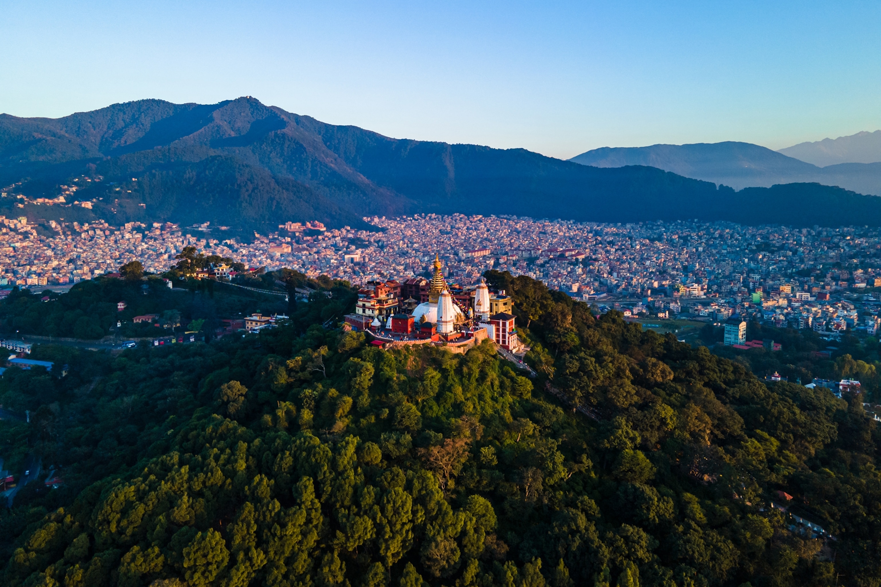 Temple on hill with Kathmandu and Himalayas behind.