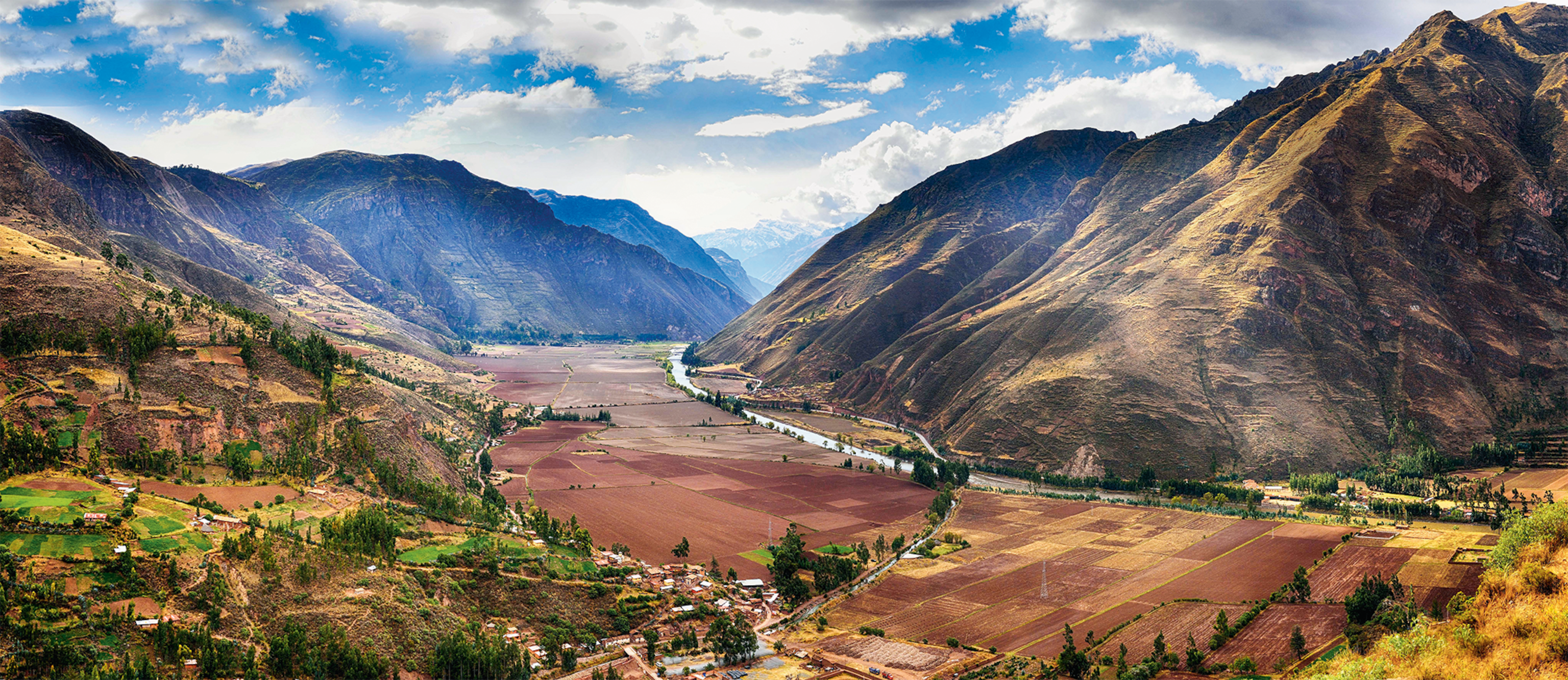 The Urubamba Valley with a river flowing through it and fertile farm land.
