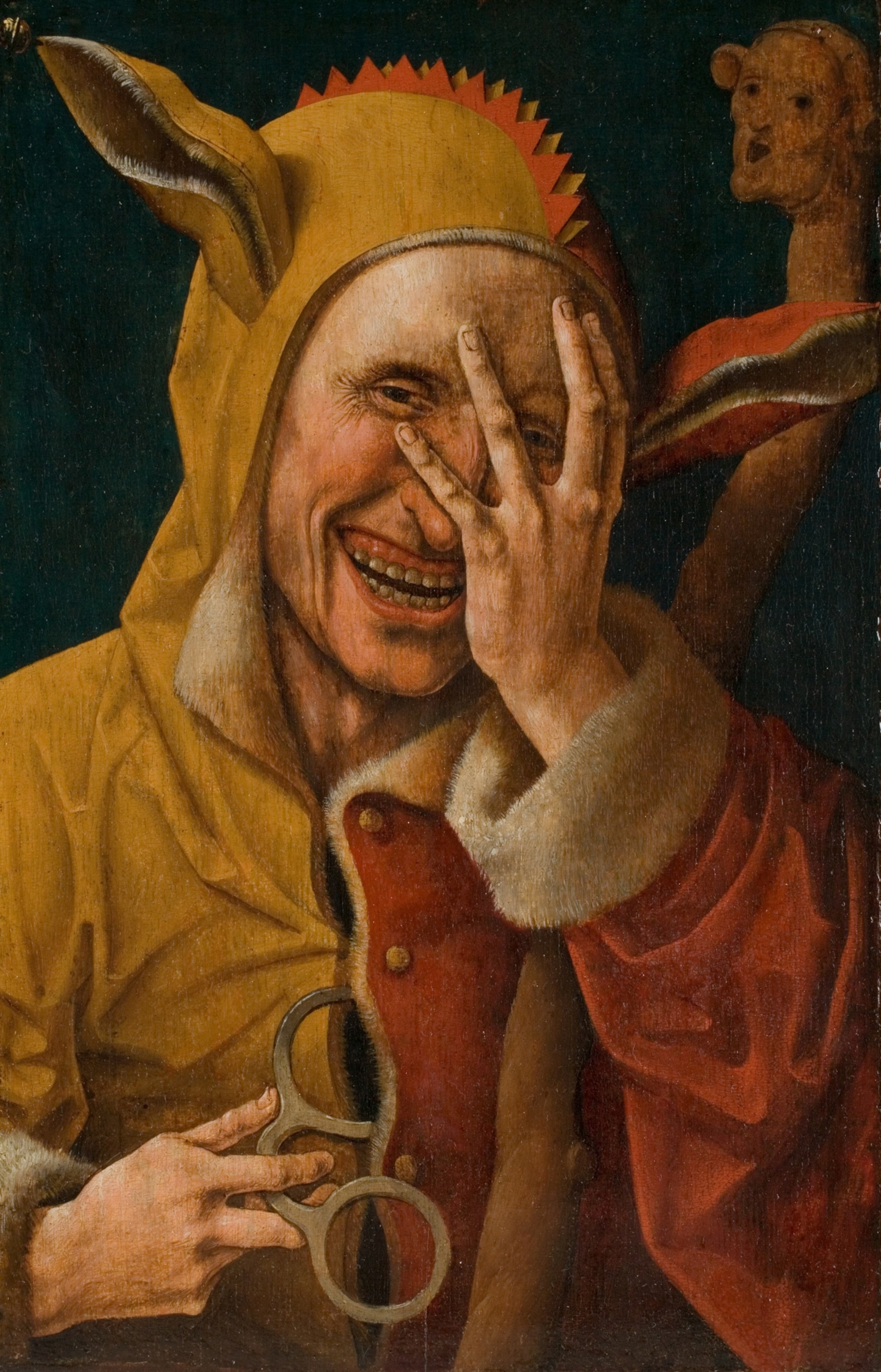 A laughing jester in a yellow and red costume with fur trim, covers part of his face with his hand, holding eyeglasses.