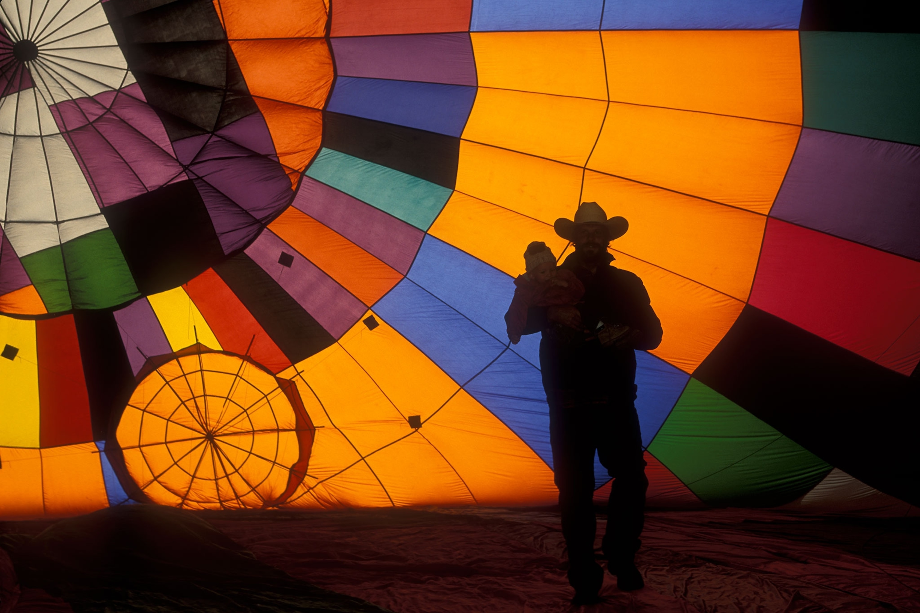 man inside multi-colored hot air balloon
