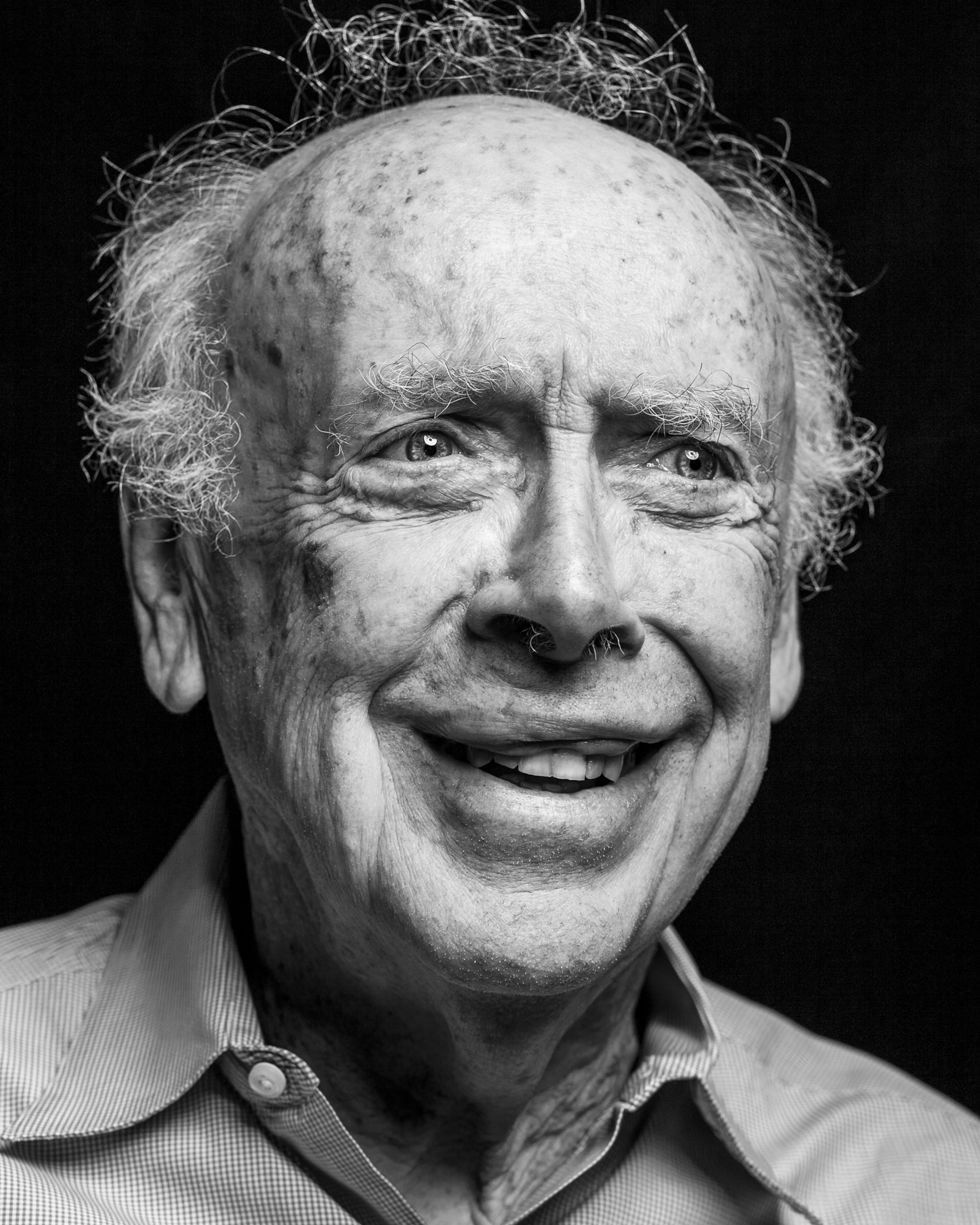 Dr. James Watson in a black and white headshot.