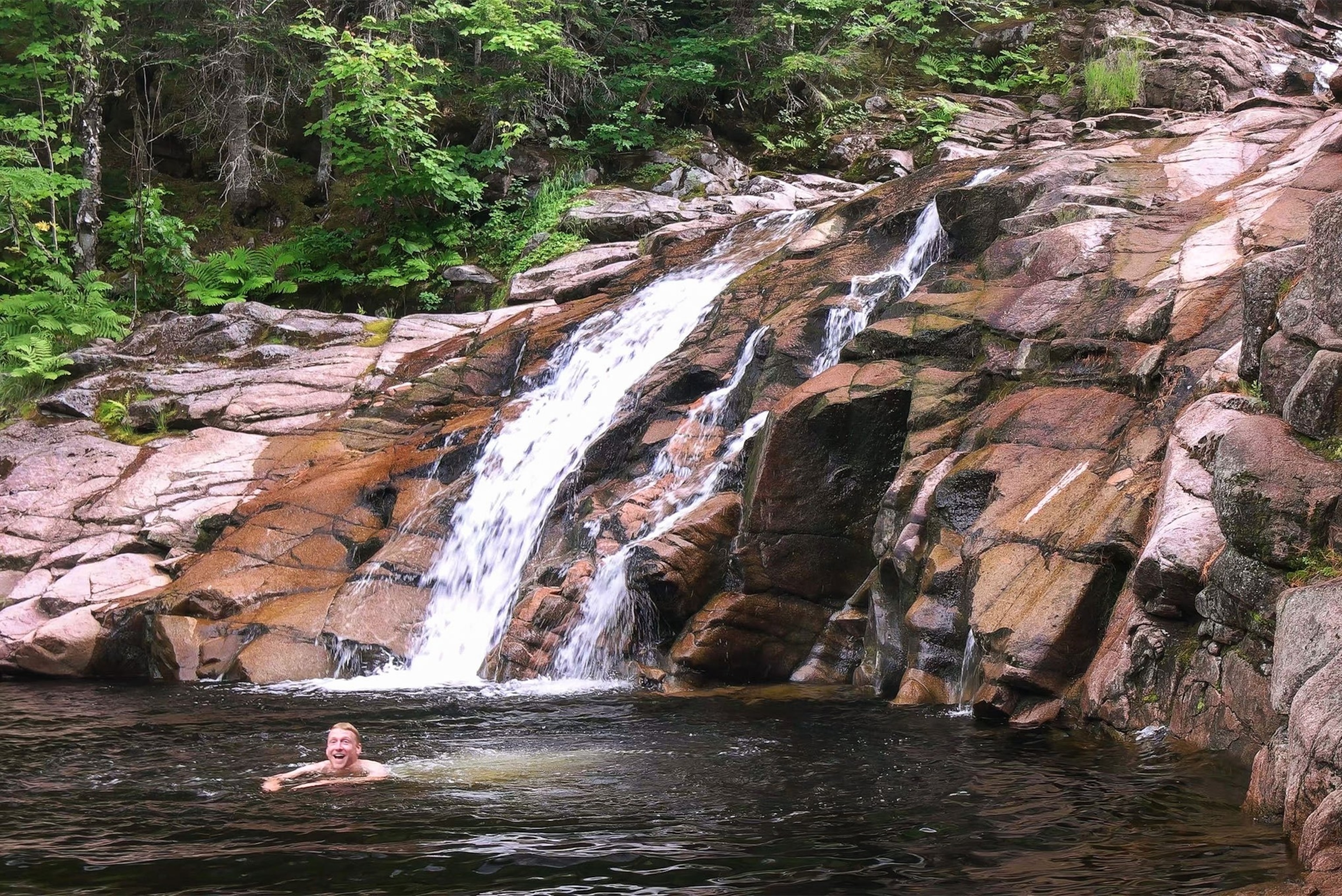 a person swimming in the Mary Ann Falls, Cape Breton.