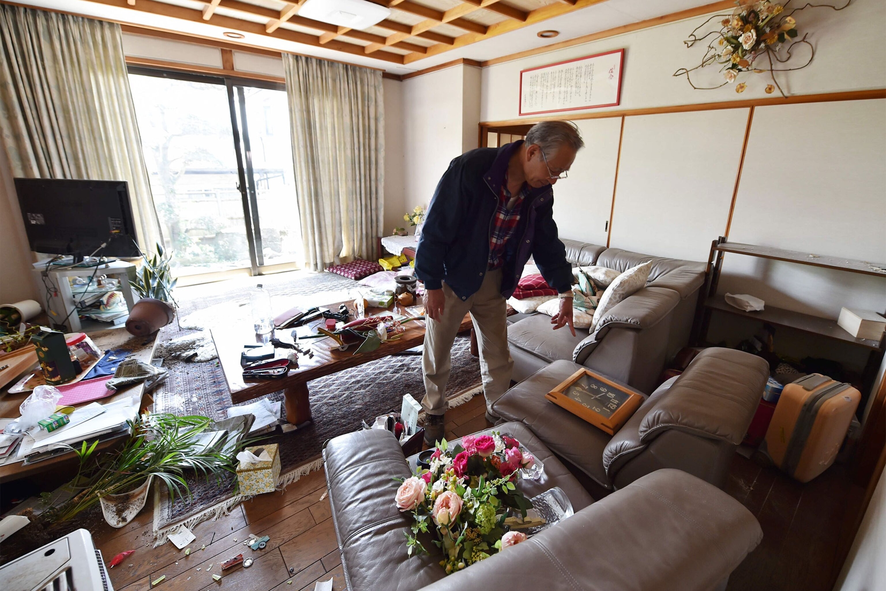 a man in his home after an earthquake in Japan