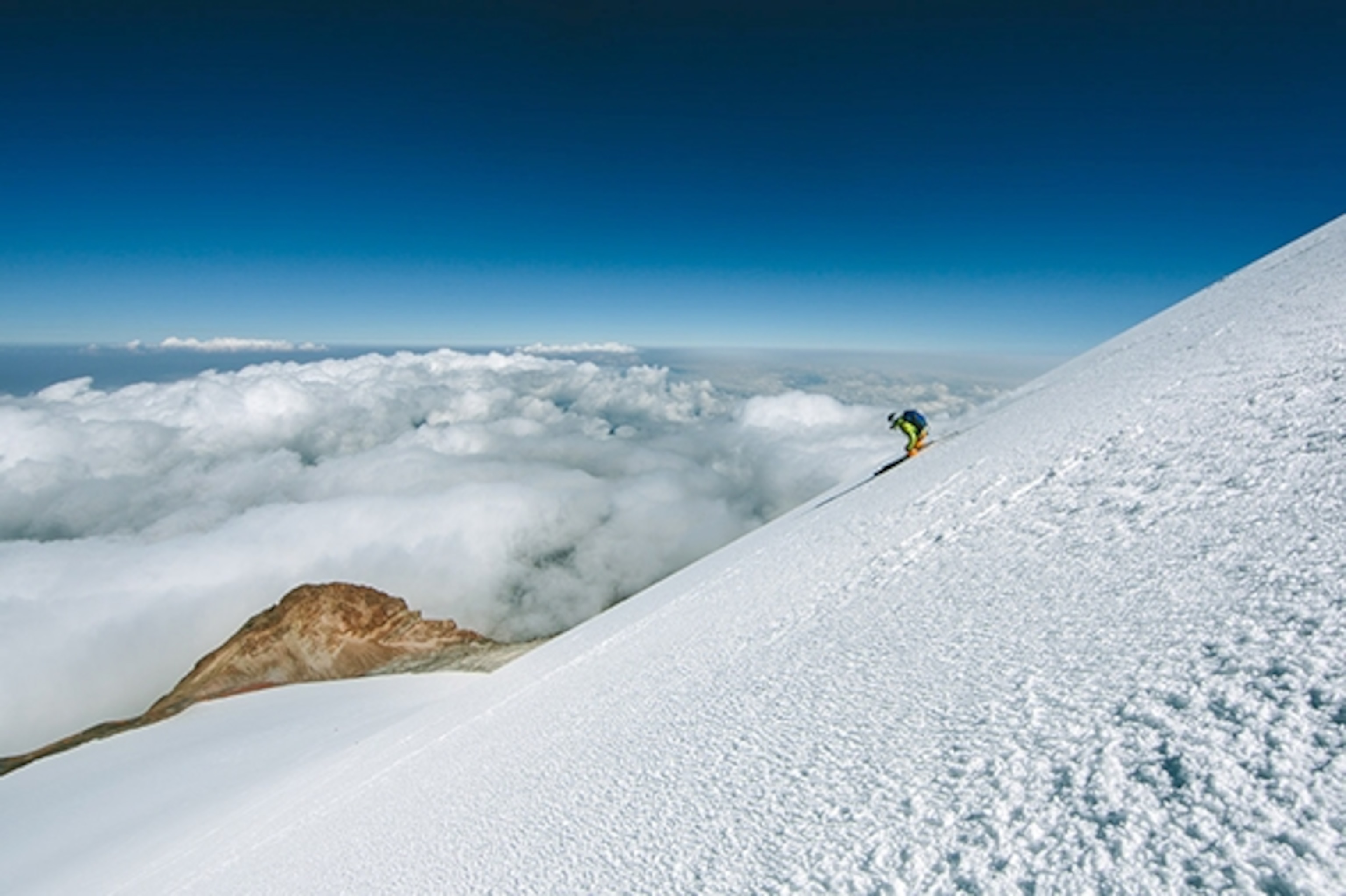 Skiing down Pico de Orizaba, Mexico, above the clouds; Photograph by Max Lowe