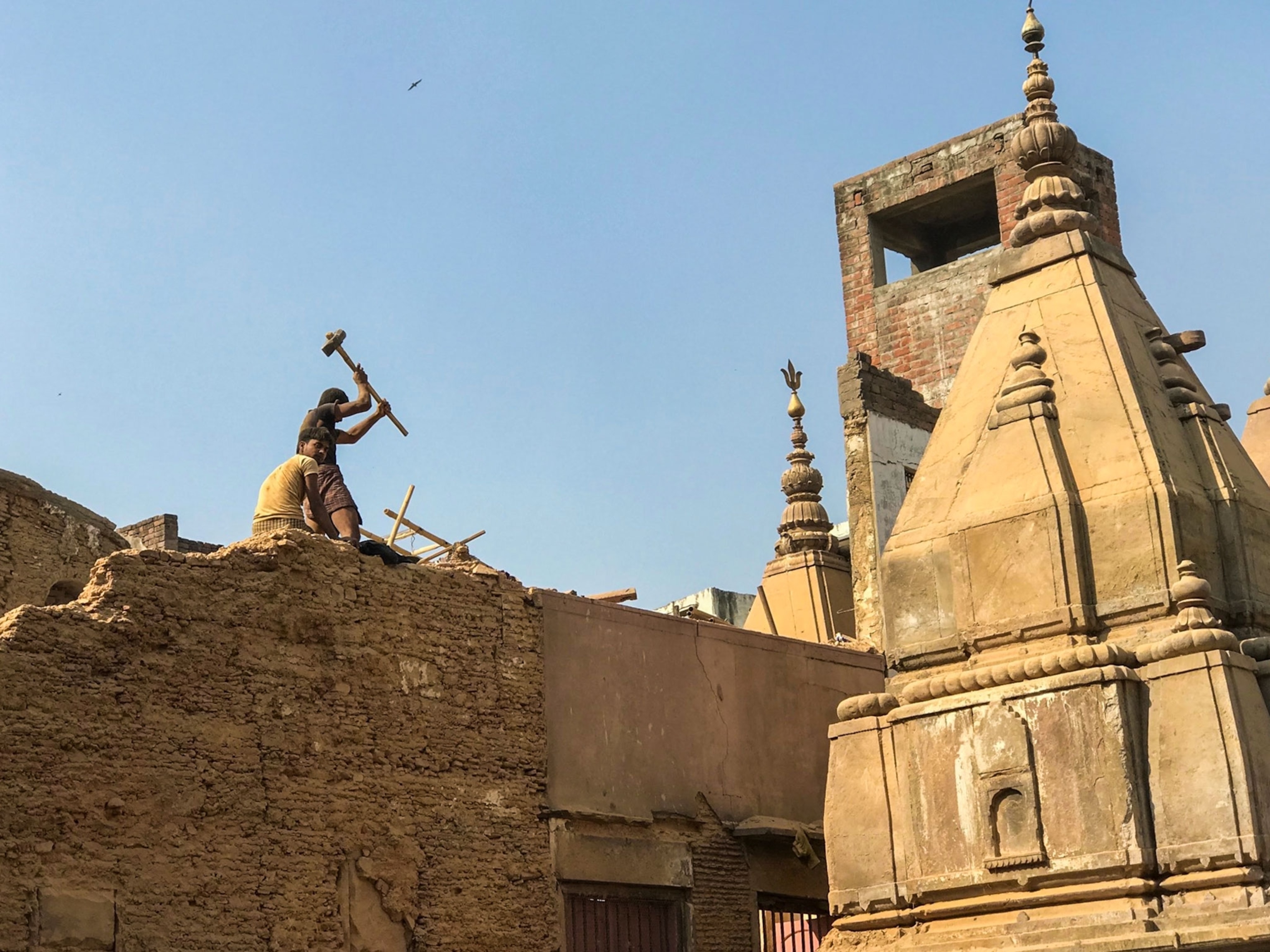 workers demolishing a building in India