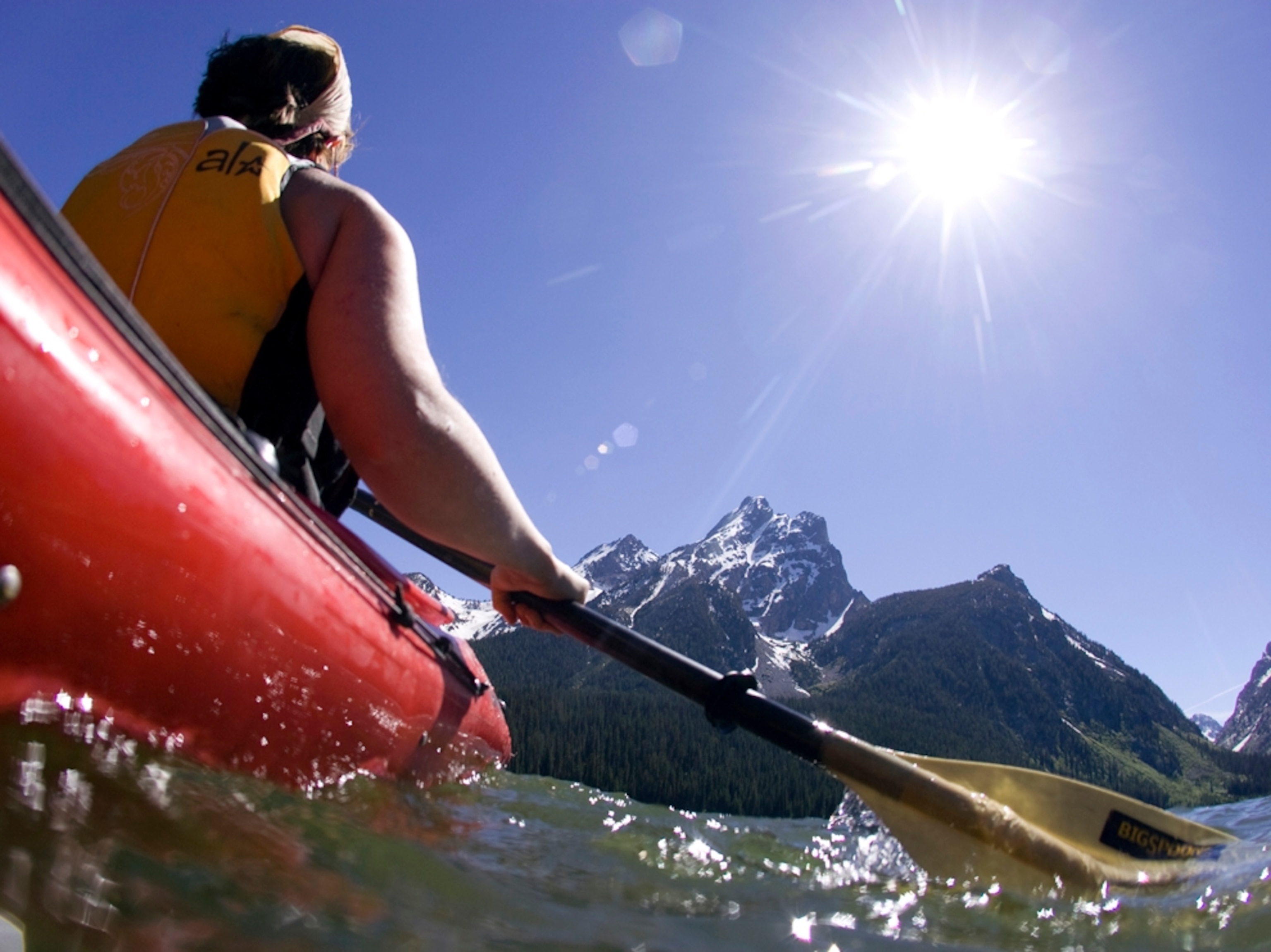 Kayaker by mountains