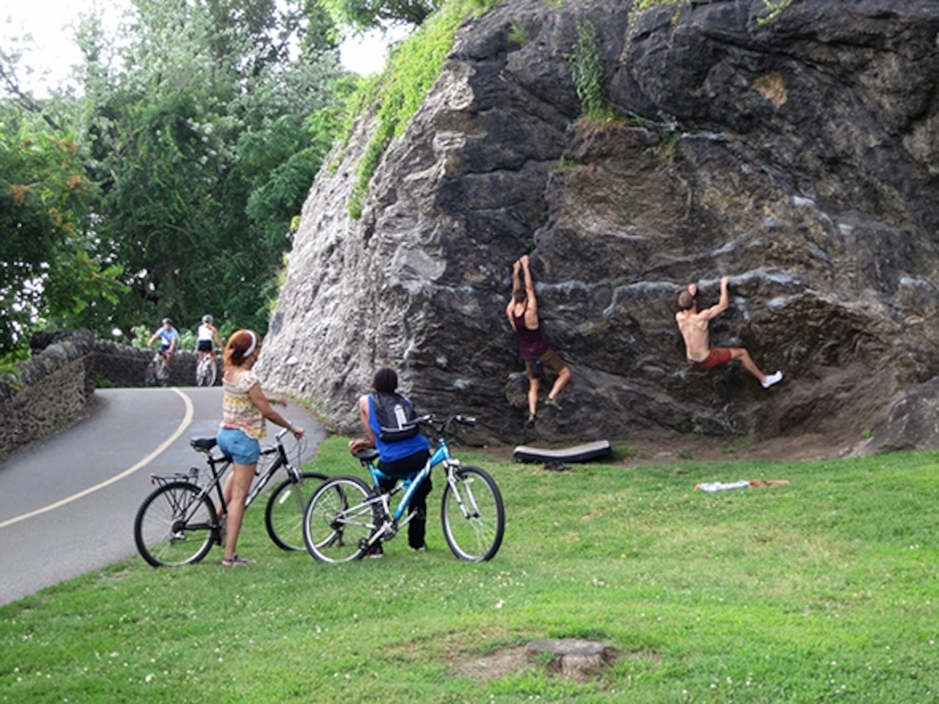 Rock climbers entertain park-goers along a bike path through Fairmont Park. (Photograph by Robert Reid)