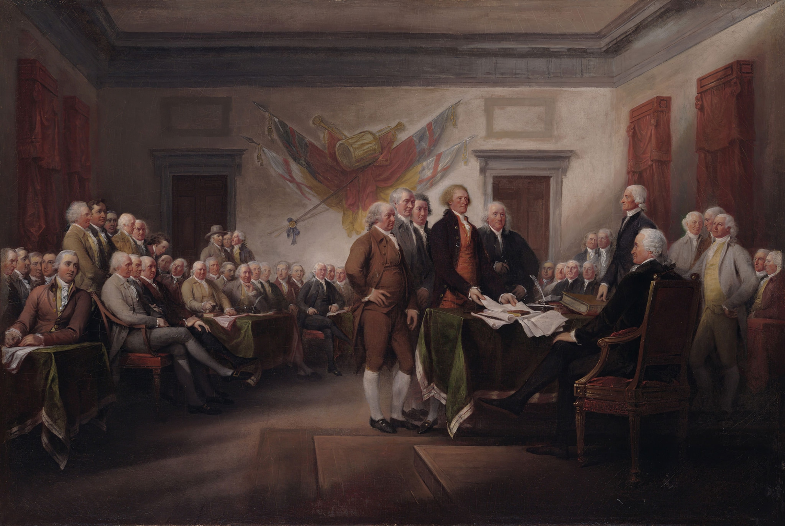 Adams stands, hand on hip, with the committee that drafted the Declaration of Independence, which Thomas Jefferson presents to John Hancock, president of Congress. Benjamin Franklin stands to Jefferson’s left.
