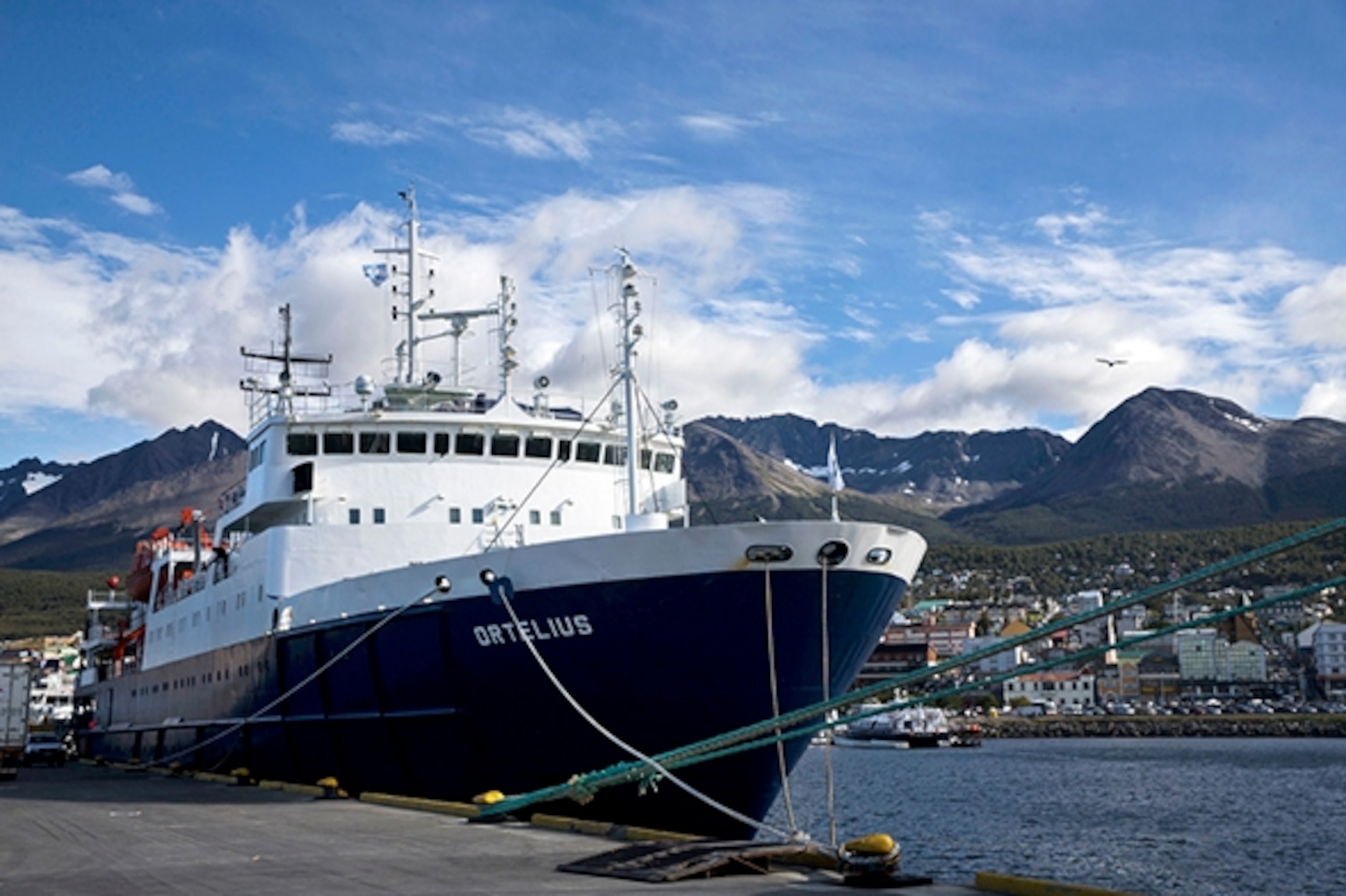 The Ortelius ship sits docked at the Port of Ushuaia on March 10, 2016. Ushuaia, considered the southernmost city in the world, is located on the Beagle Channel in the Tierra del Fuego archipelago at the southern tip of Argentina. The channel, which is named for the British ship Beagle that Charles Darwin used to explore the area in the 1830's, is a gateway to Antarctica for the ships carrying tourists, scientists, and supplies to the Antarctic Peninsula and beyond; Photograph by Carolyn Van Houten