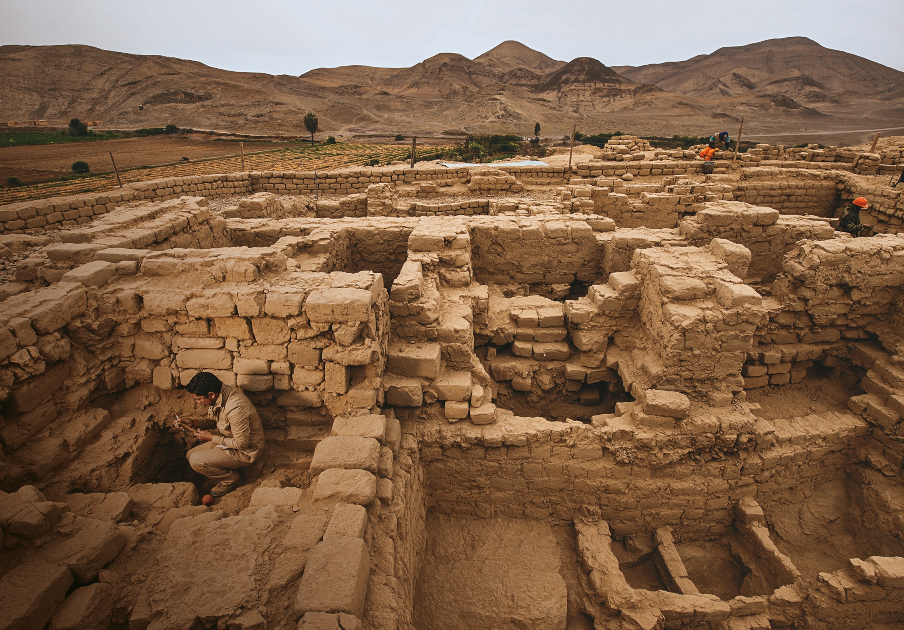 Archaeologist Roberto Pimentel Nita reviews a find within the mausoleum at El Castillo de Huarmey.
