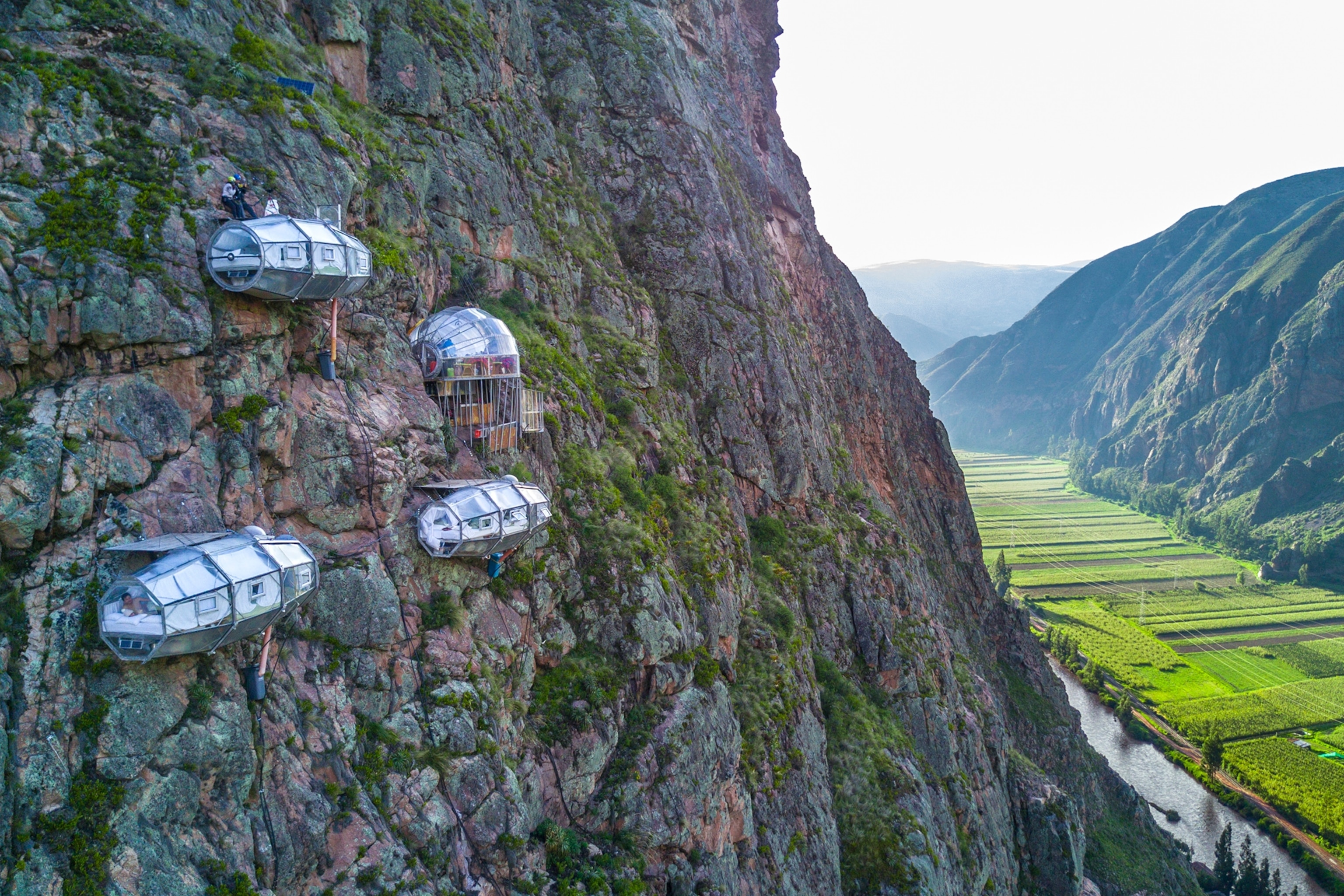 sleeping pods on the side of a cliff