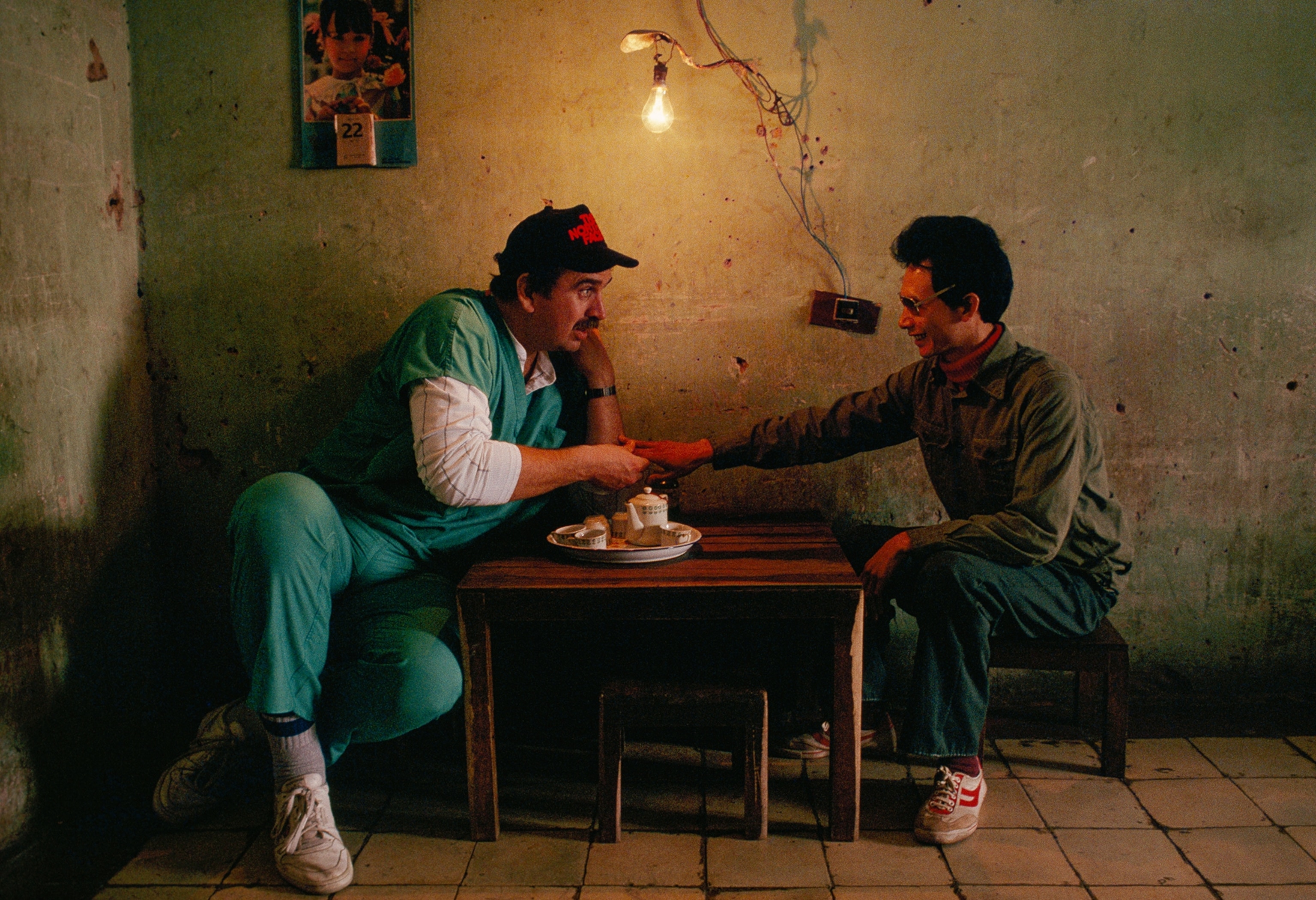Operation Smile volunteer Bill Franke carrying a girl to the recovery room in 1989.