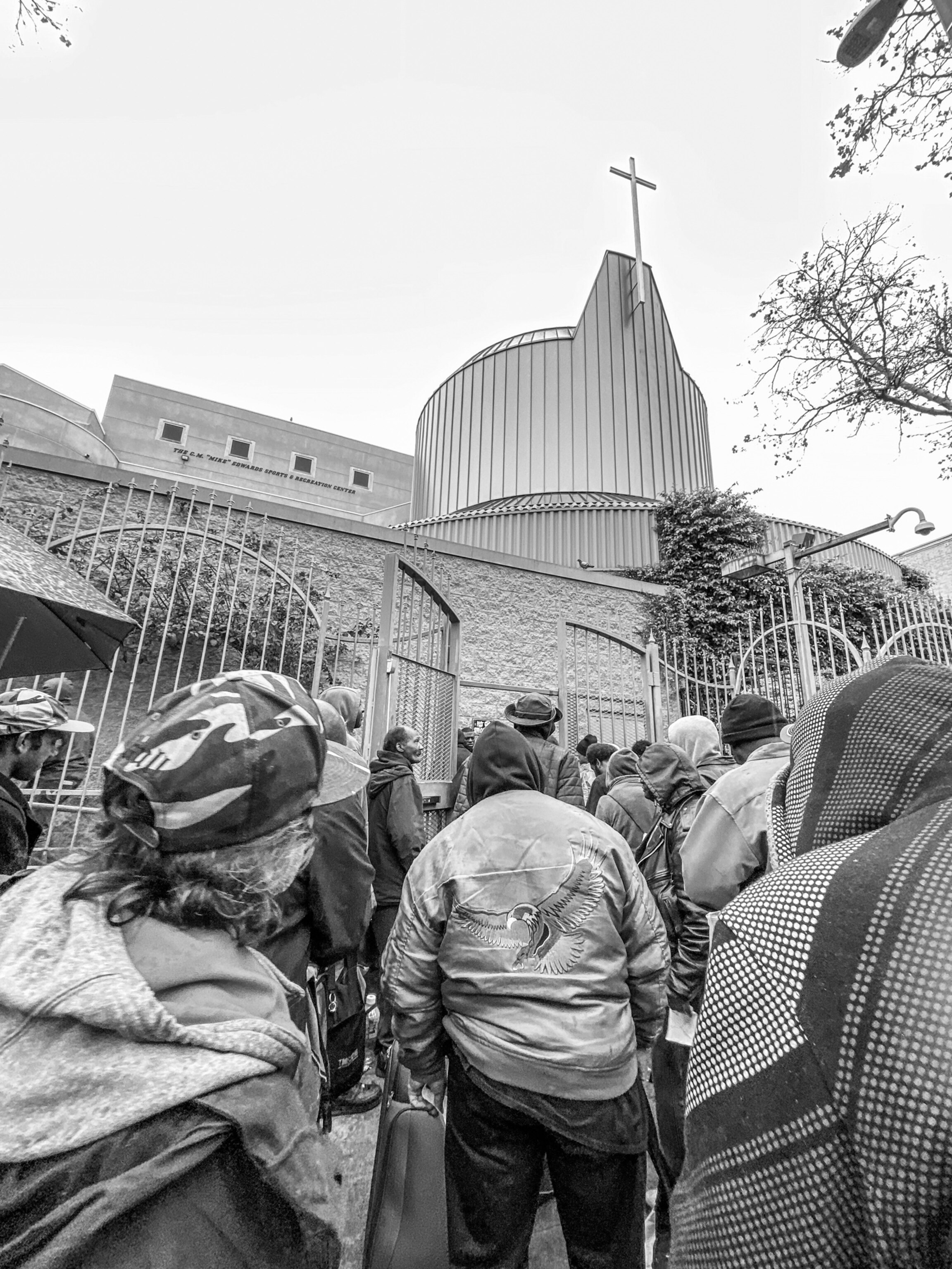 a group of people walking into a church during the day