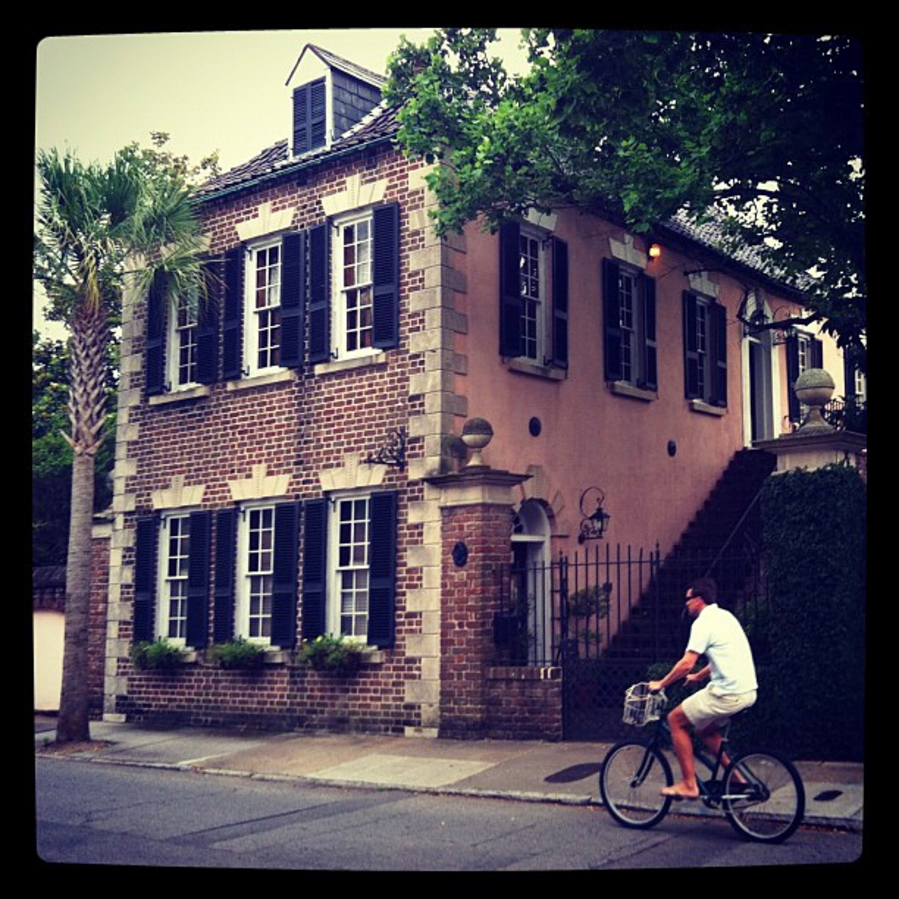 Instagram photo of man biking past homes in Charleston, South Carolina