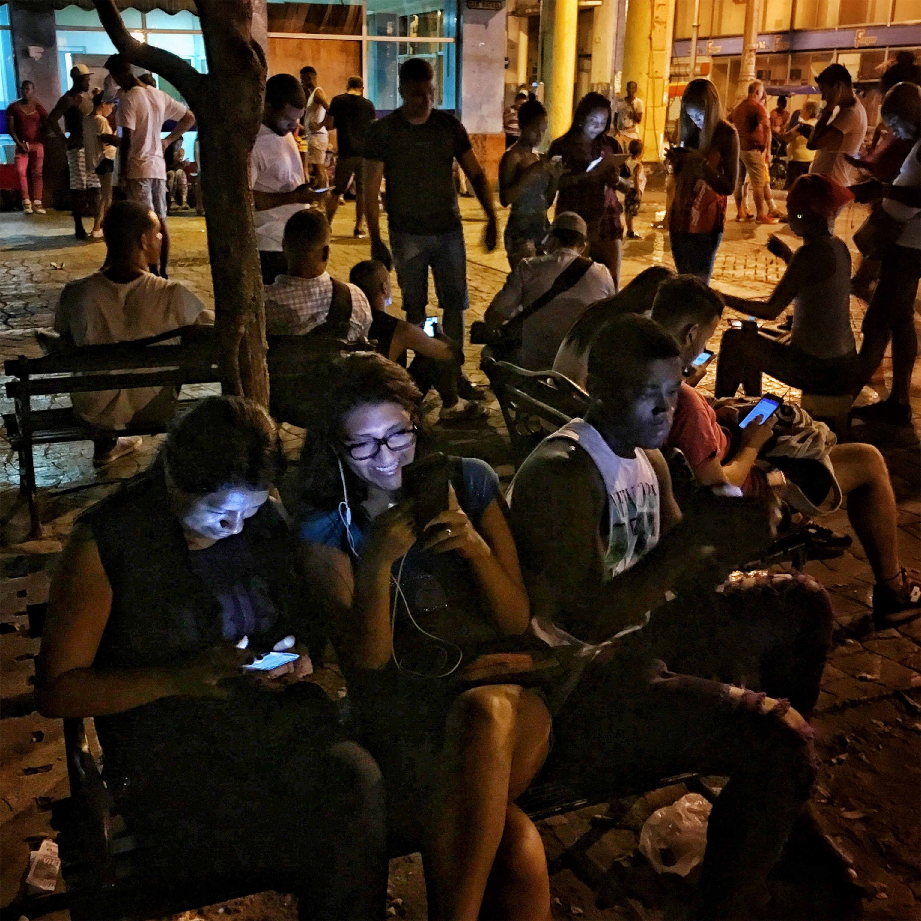 people on their phones in Havana, Cuba