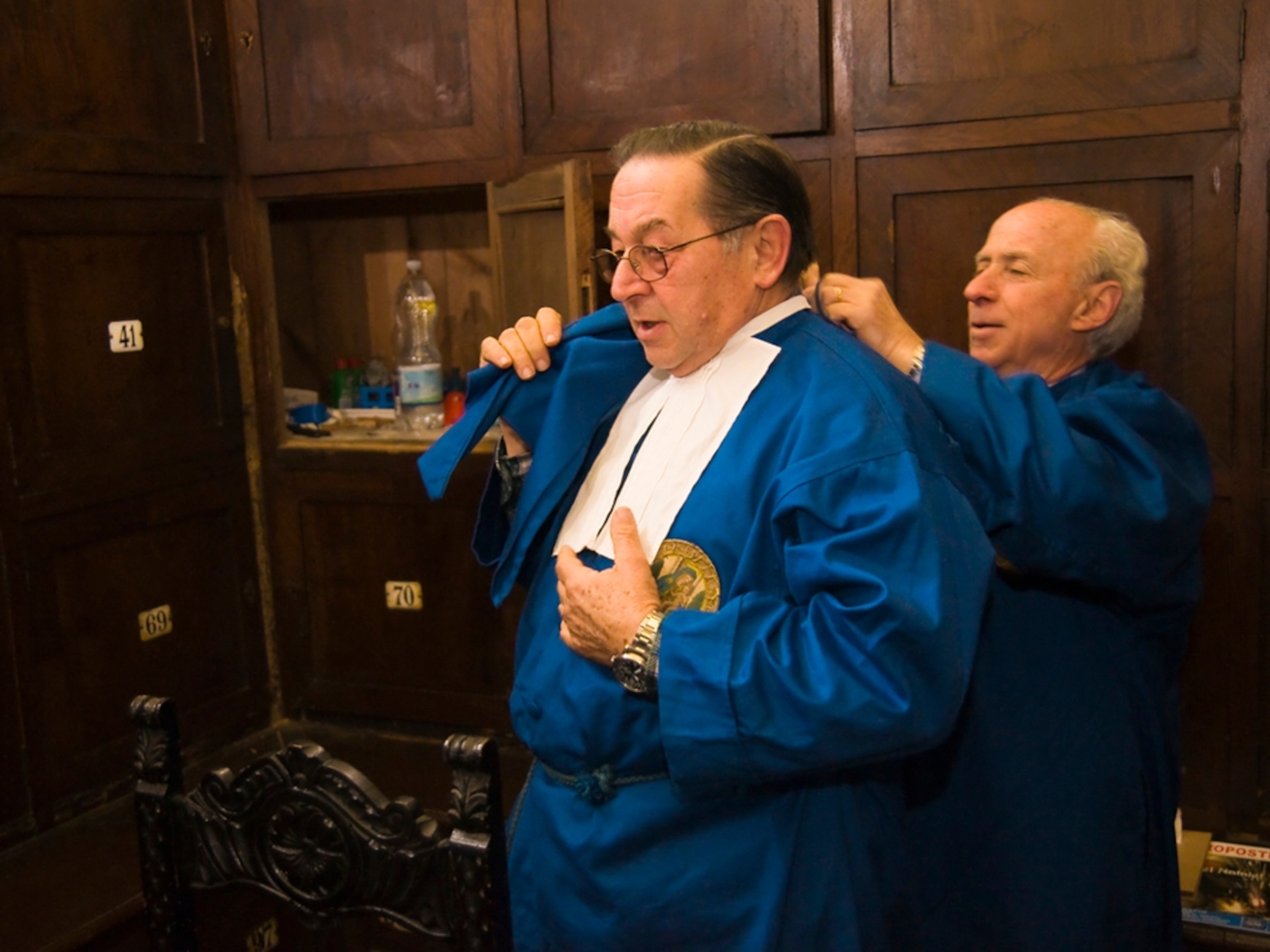 Men don ceremonial apparel for event, Rome