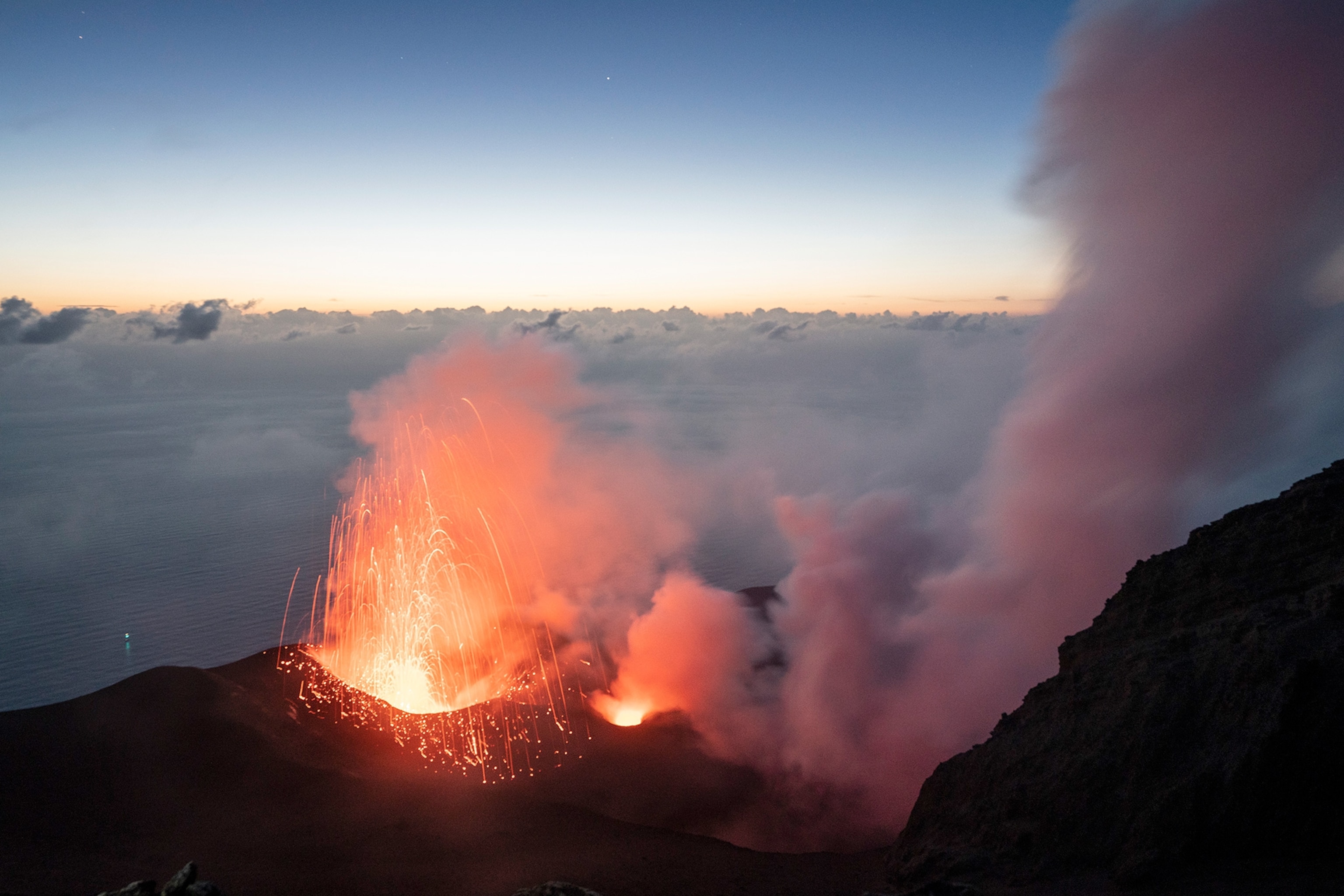 a crater of Stromboli volcano erupting at night in Stromboli, Italy