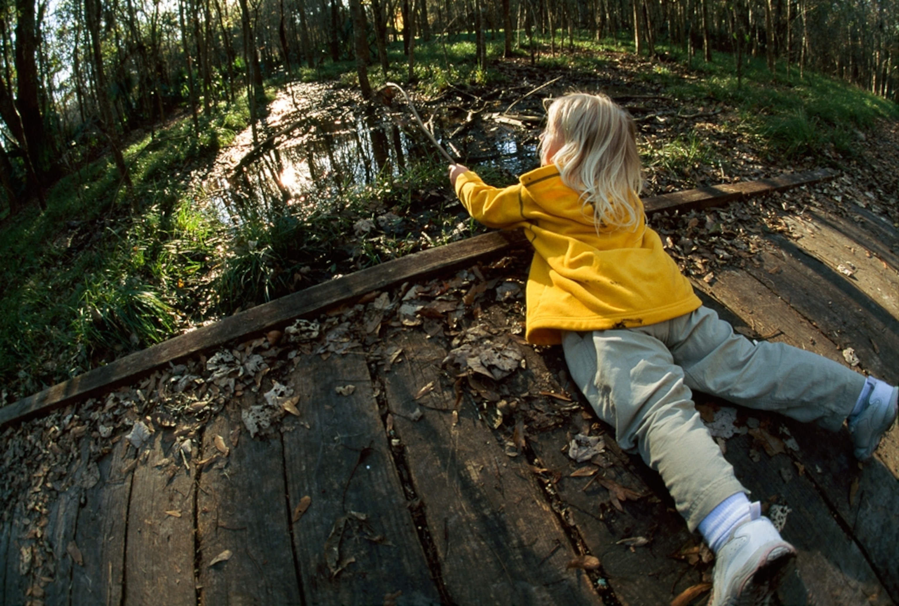 A girl lies on a boardwalk in Jean LaFitte National Historical Park and Preserve, one of the U.S. national parks threatened by the Gulf oil spill.