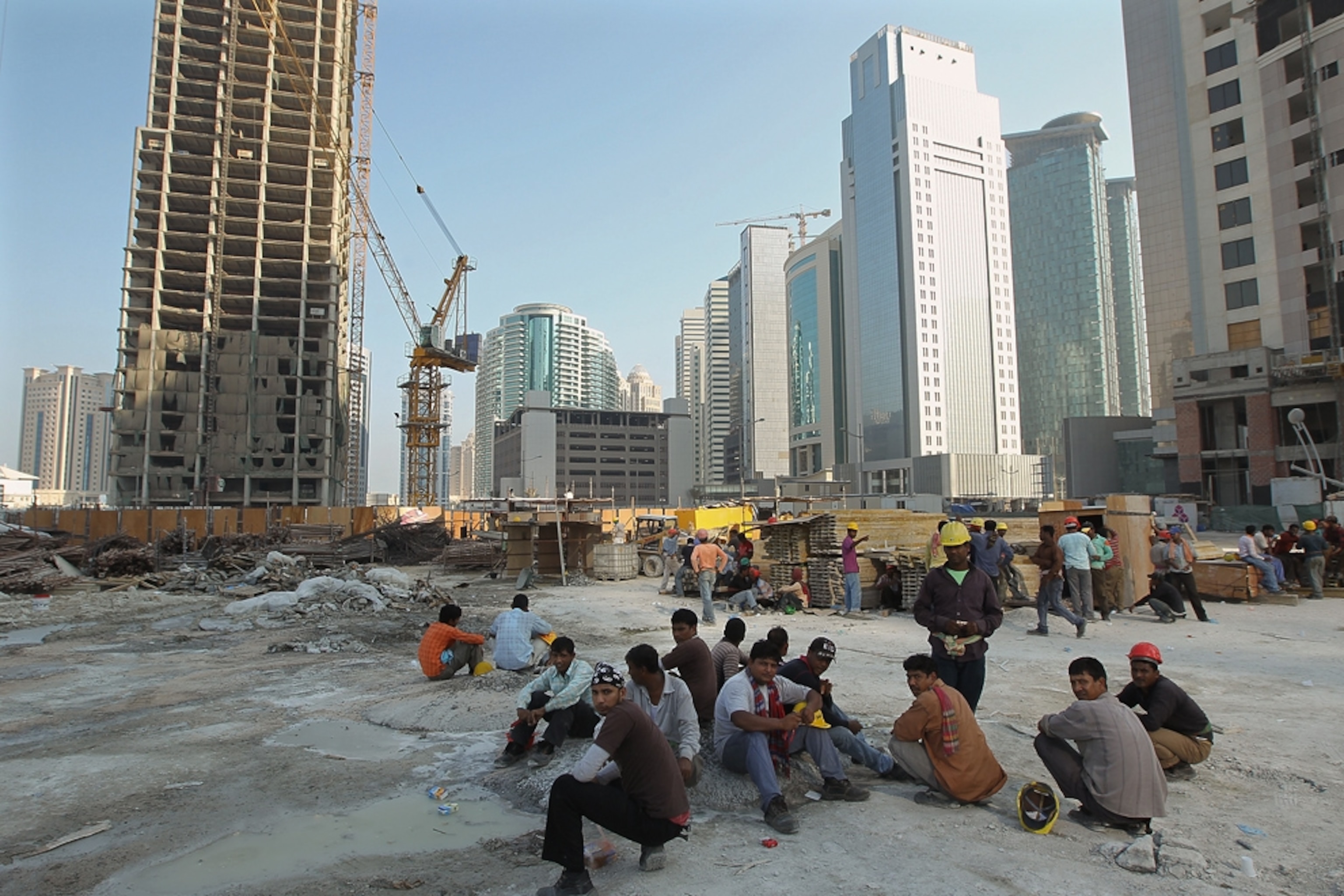 Construction workers on break near new office buildings and hotels in Doha