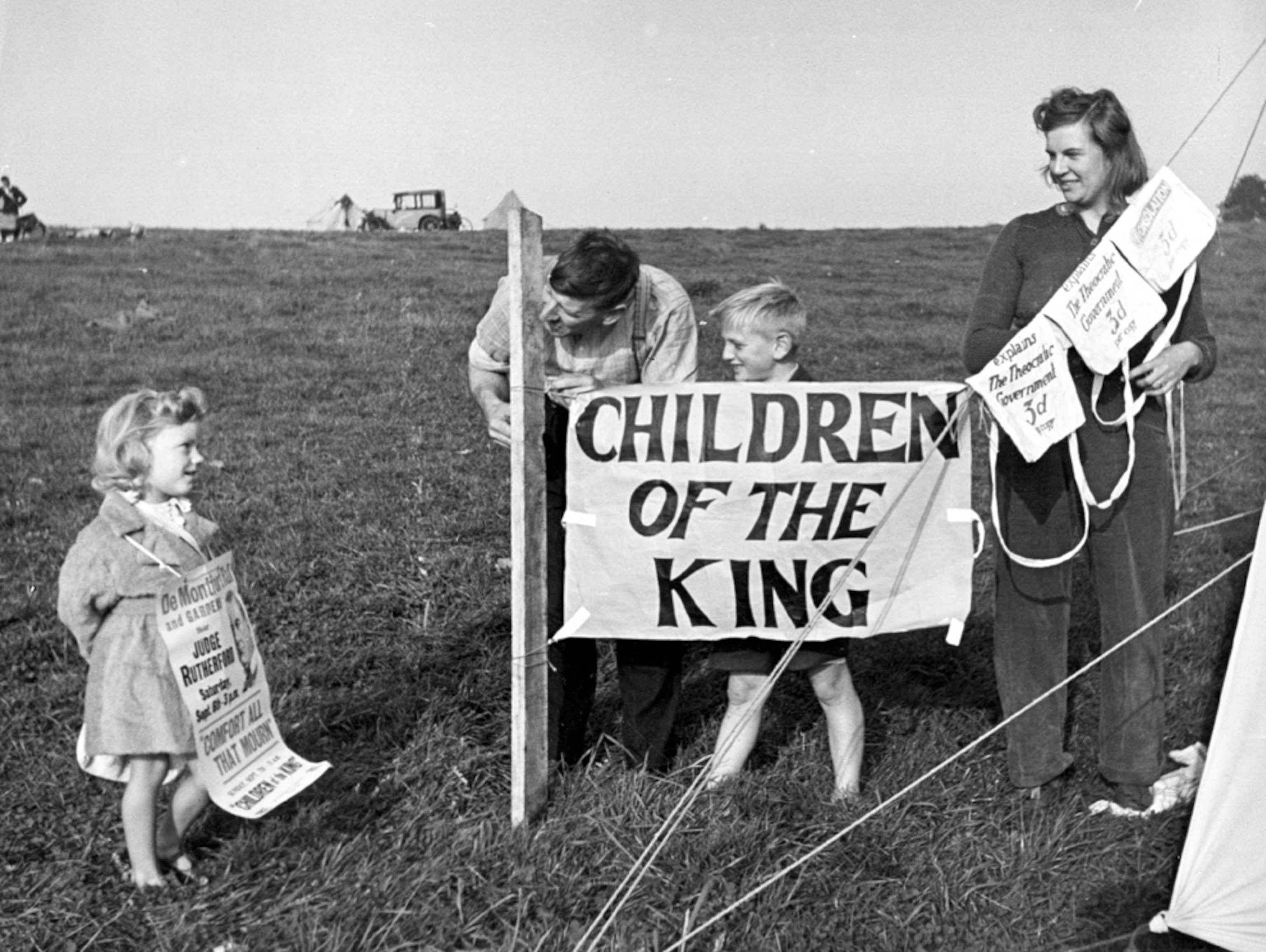 Children display posters for the Jehovah's Witnesses.