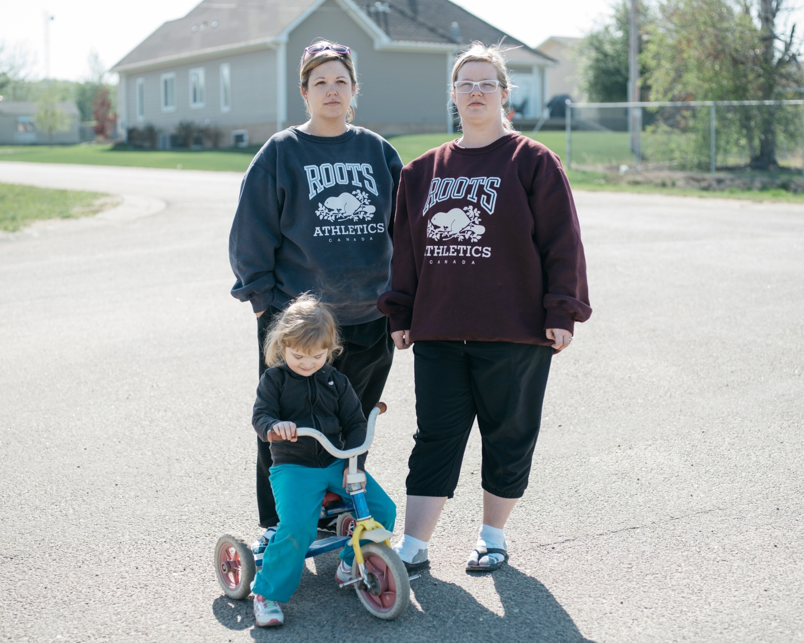 adult sisters and little girl on bike